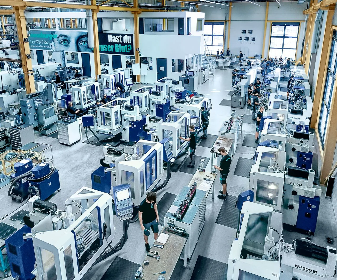 Modern factory training workshop with precision machine tools and workbenches for apprentice mechanical technicians in Wolfurt.