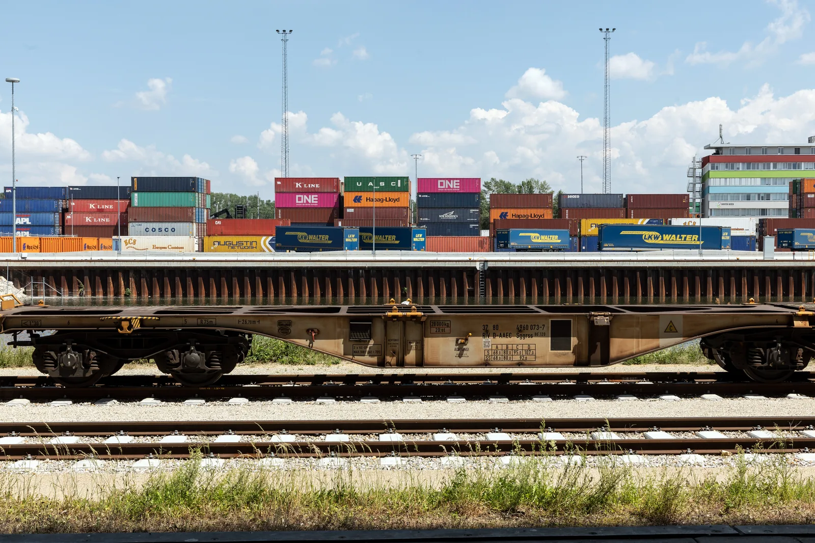 Container shipping terminal with stacked cargo freight boxes and gantry cranes at the Port of Vienna on the Danube.
