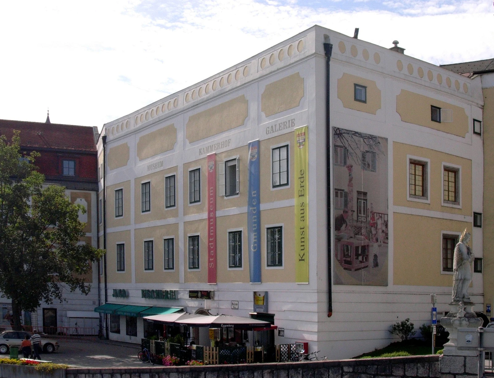Historic multi-story Kammerhof building along the waterfront in Gmunden, Austria.