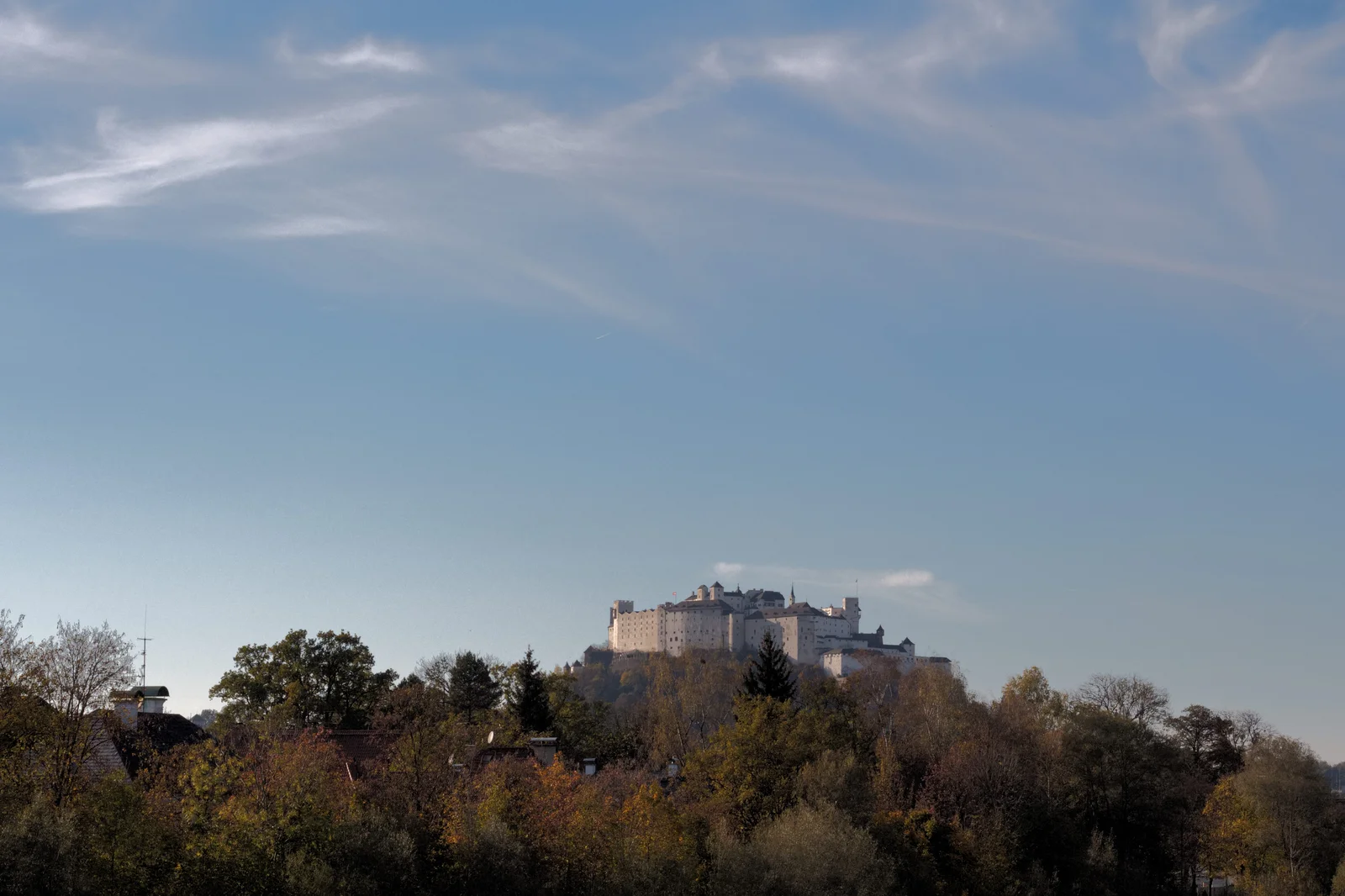 Medieval stone fortress overlooking the rooftops and spires of historic Salzburg.