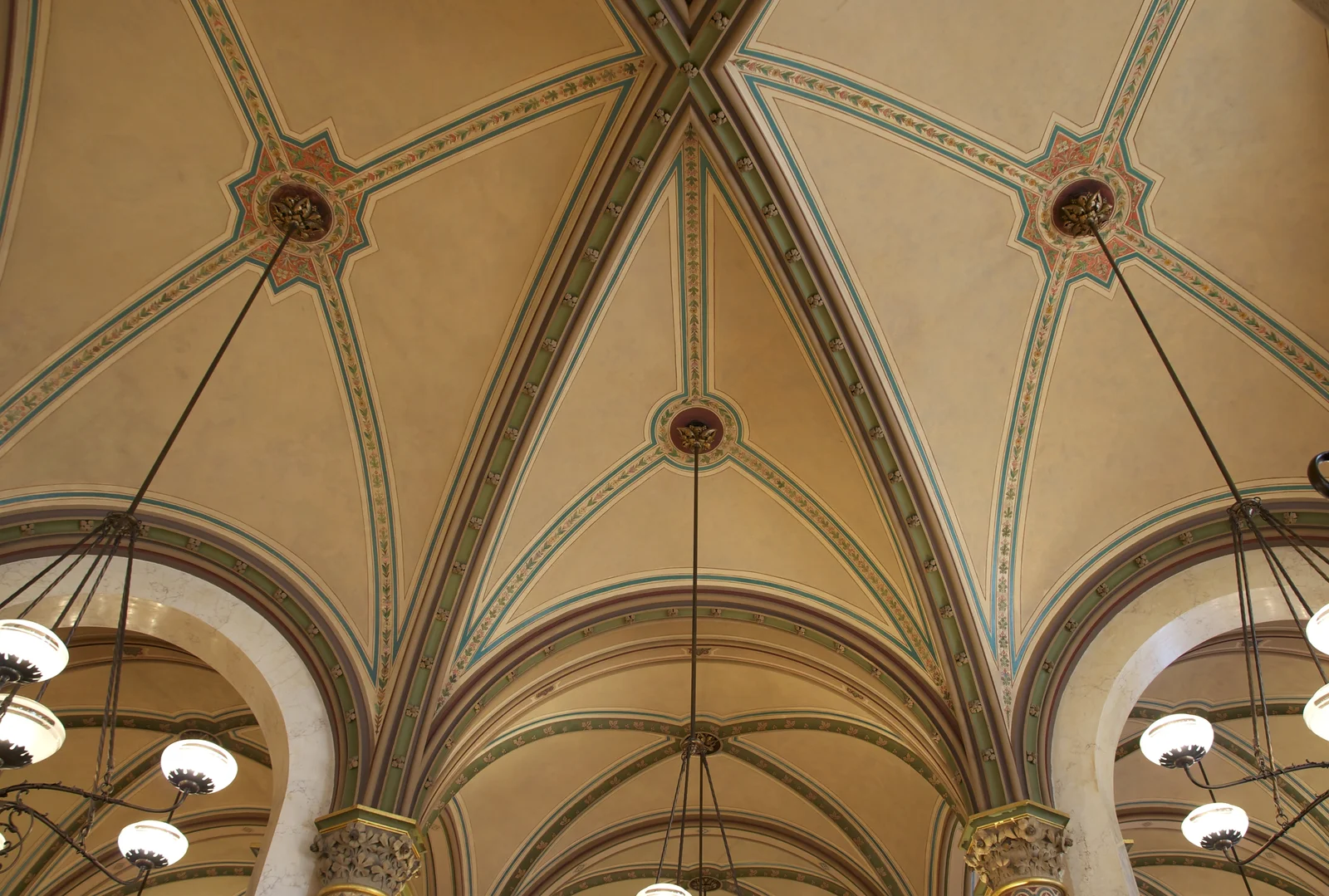 Magnificent arched ceiling and marble pillars in a grand historic Viennese coffeehouse.