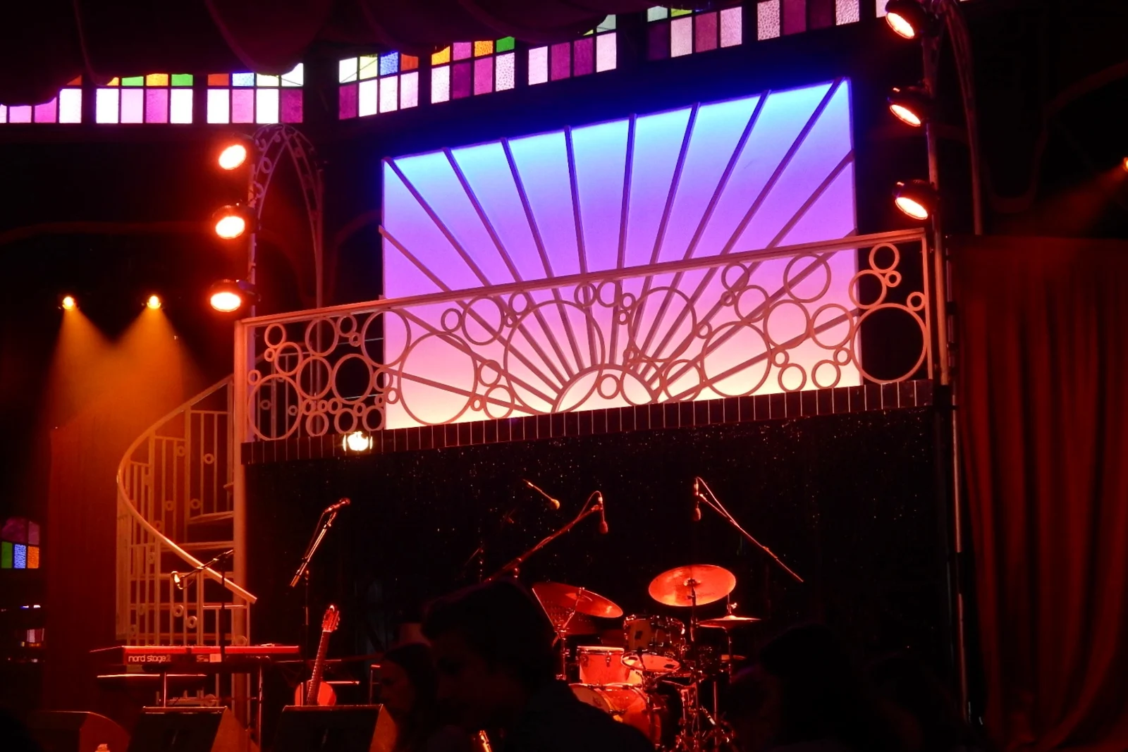 Interior view of an ornate traveling Spiegeltent venue with mirrors and circular stage.