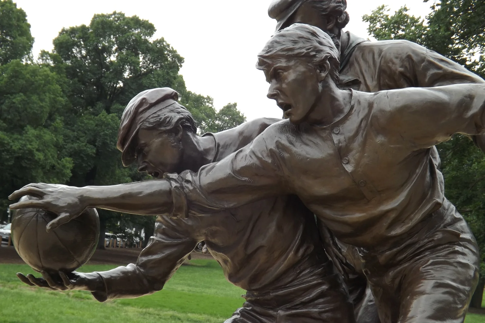 Bronze statue outside the Melbourne Cricket Ground depicting nineteenth-century footballers contesting the ball.