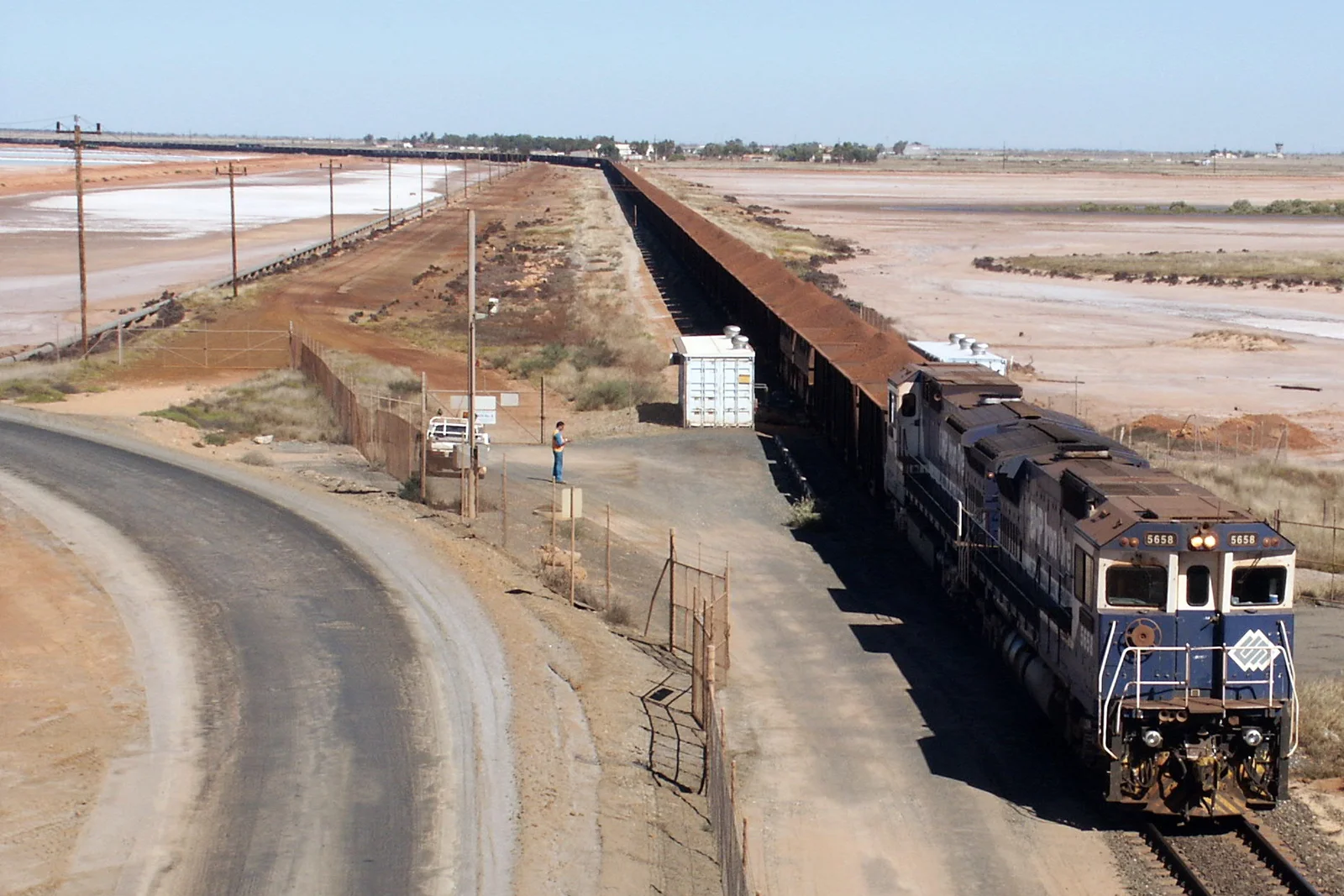 Industrial freight train approaching port facilities in Port Hedland Western Australia.