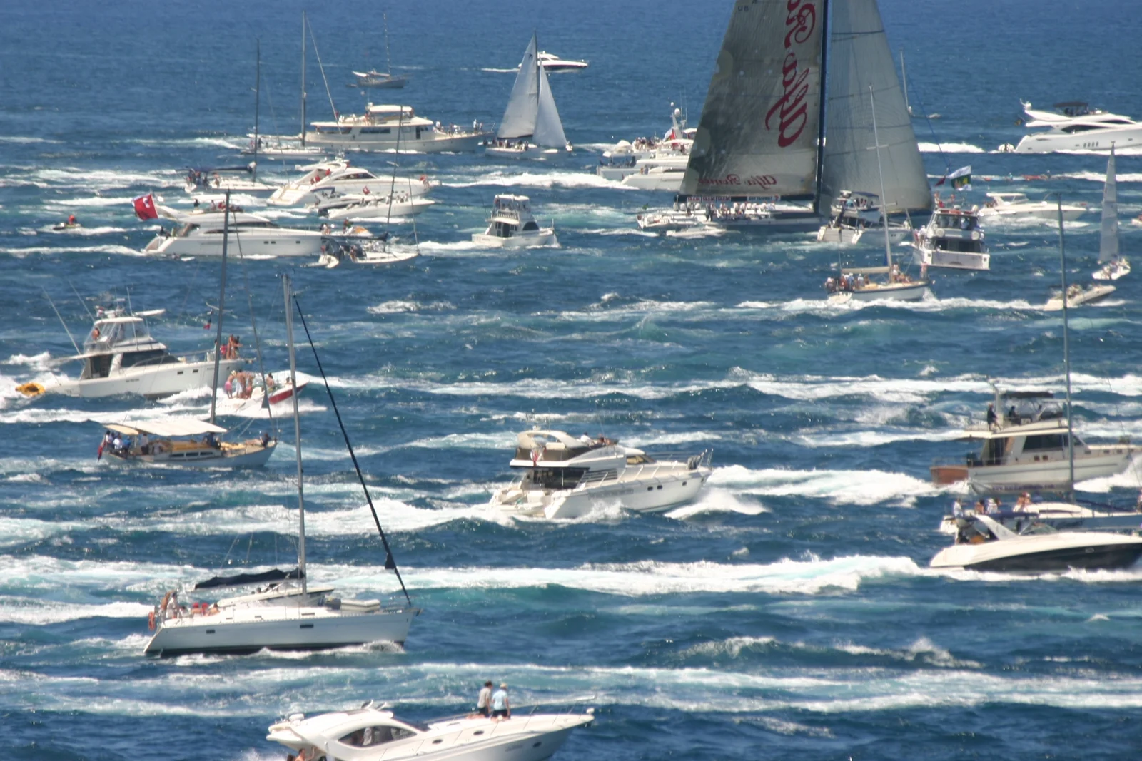 Offshore racing yacht in full sail powering across open ocean swells.