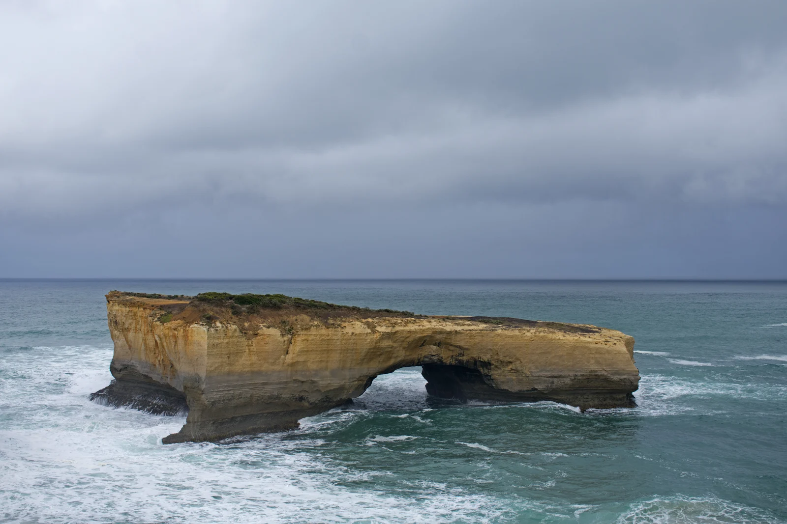 Dramatic offshore limestone arch of London Bridge after the collapse of its connecting mainland span.