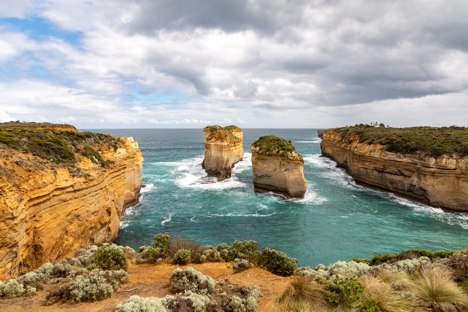 Sheer vertical limestone sea cliffs and turbulent coastal waters along the Shipwreck Coast.
