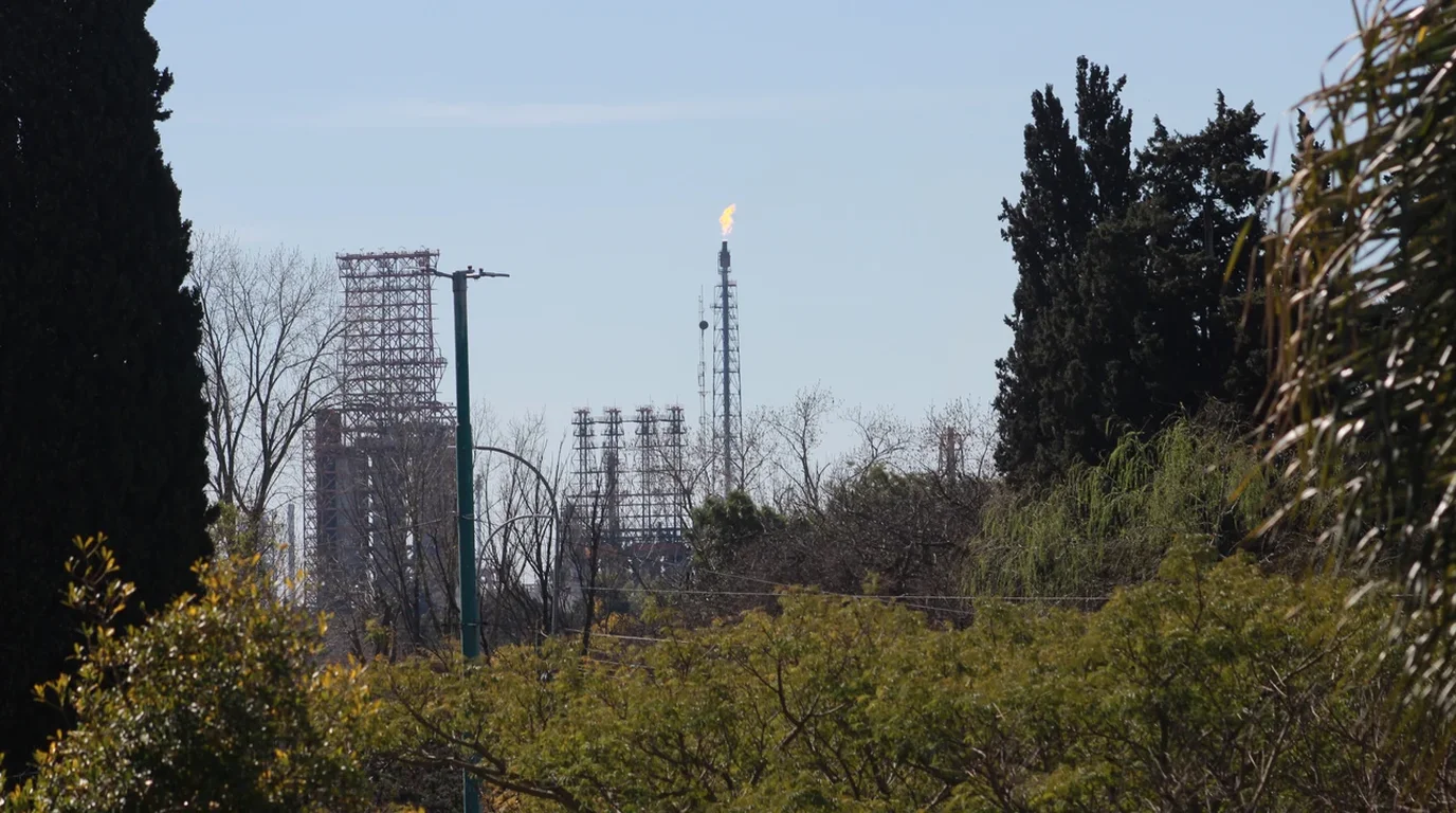 Tall fractionating towers, heat exchangers, and distillation columns at a modern petroleum refinery complex.