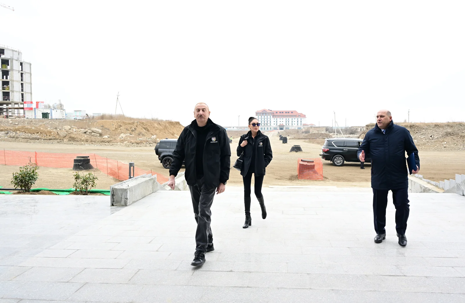 Contemporary stone and glass building of the regional mugham center set against open grounds.