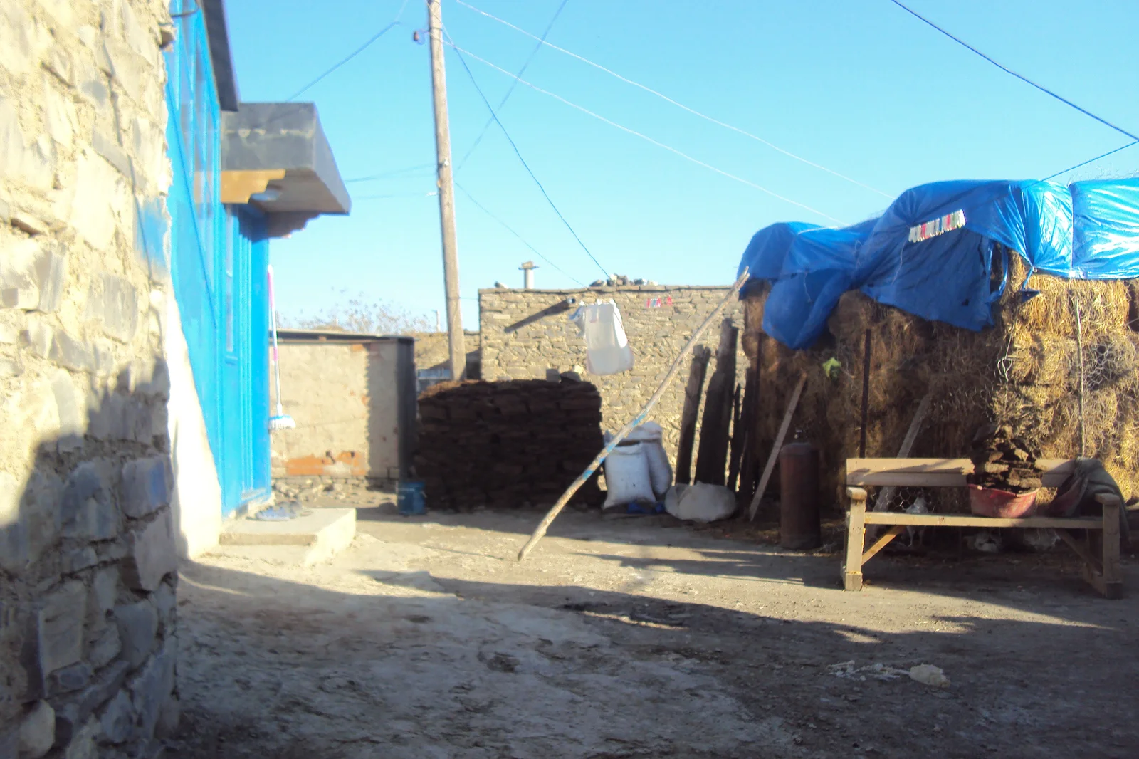 Steep cobblestone pathways and rough-hewn limestone walls of terraced homes in Khinalig.