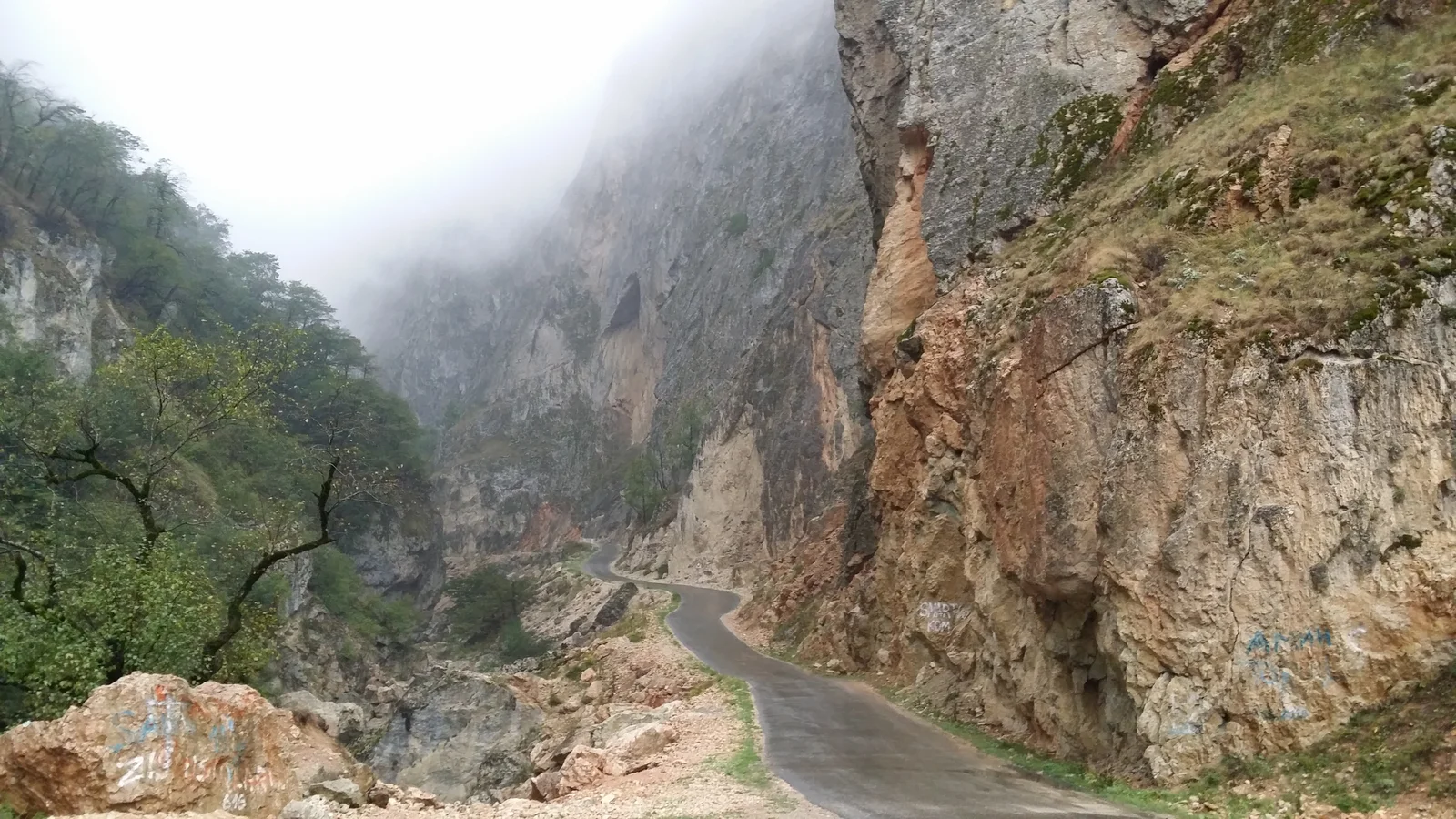 Narrow road and gorge pass running through rugged rocky Caucasus mountain valleys towards Khinalig.