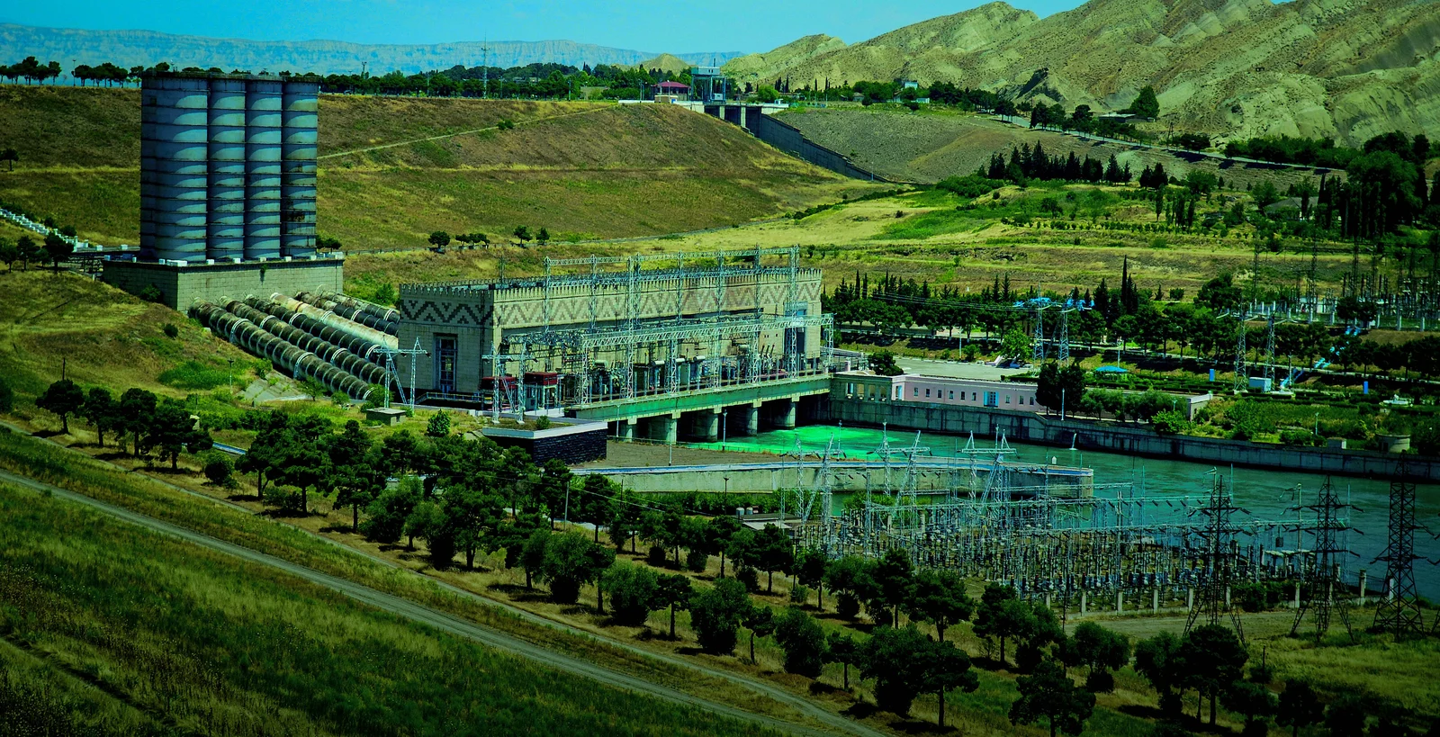 Vast blue waters of the Mingachevir reservoir under a sunny sky with distant hilly shores.