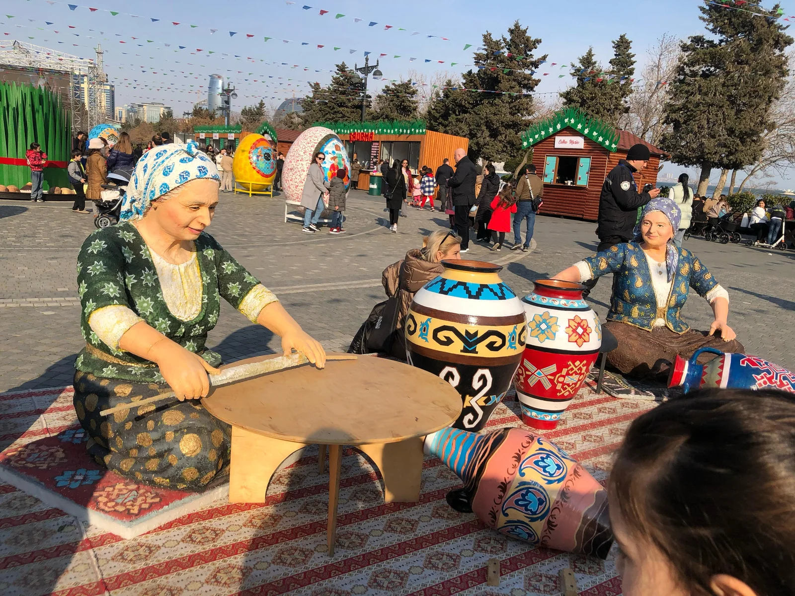 Festive outdoor square in Baku decorated for the Novruz holiday with traditional displays.