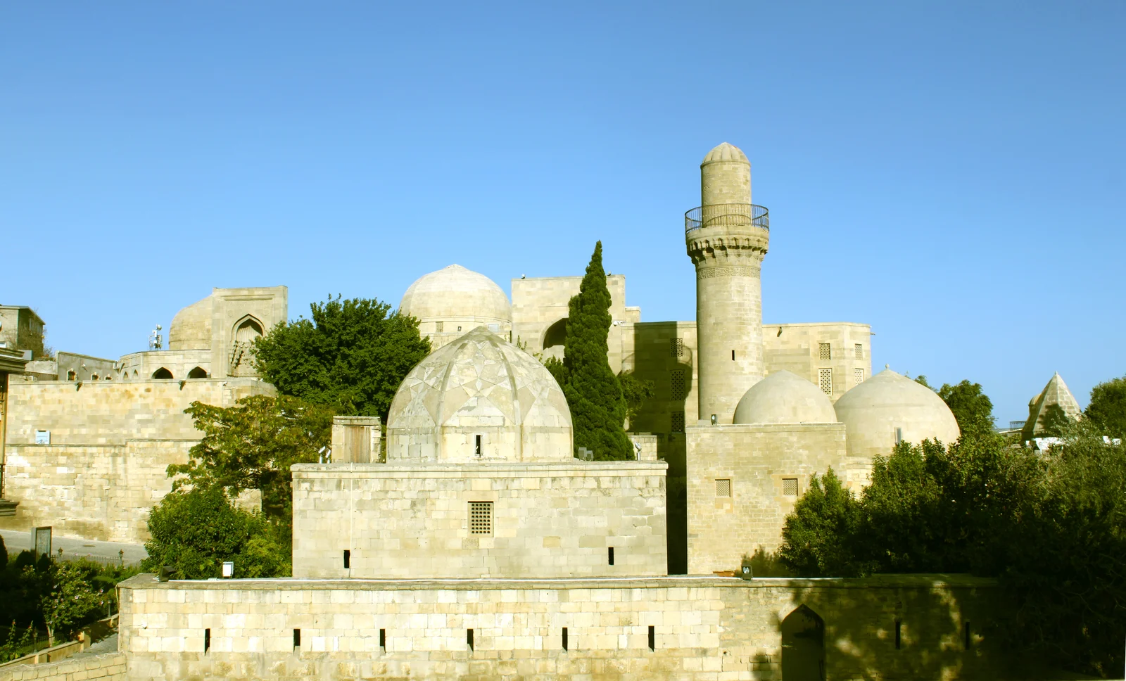 Sandstone courtyards, domed halls, and arched pavilions of the Shirvanshahs Palace complex.