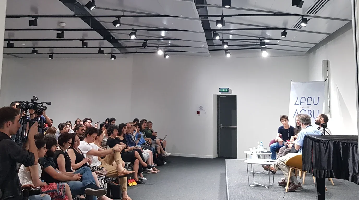 Cultural professionals and artists seated in an auditorium discussing international arts cooperation and cultural diplomacy.