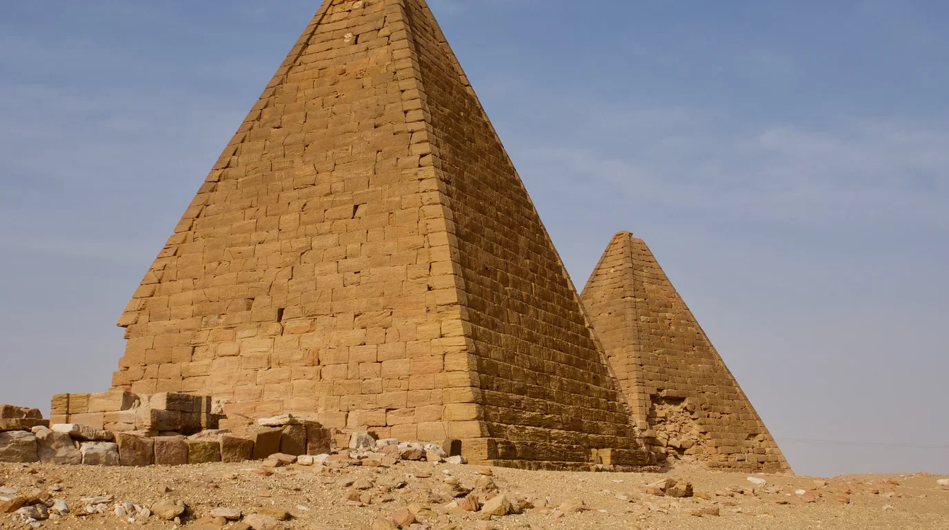 An expansive outdoor archaeological field of ancient carved limestone monolithic tombs and grave markers under open skies.