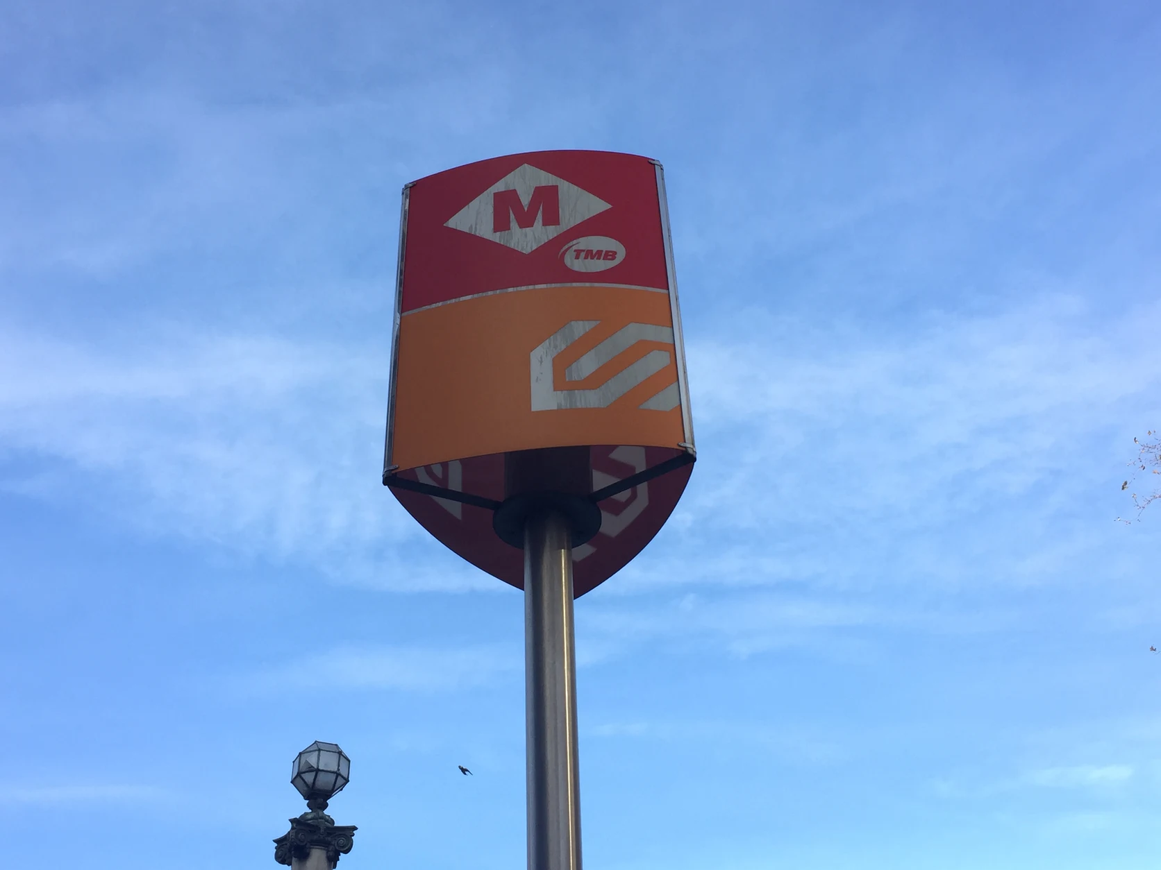 Transit wayfinding totem connecting TMB metro lines with FGC regional rail services at Plaça de Catalunya.