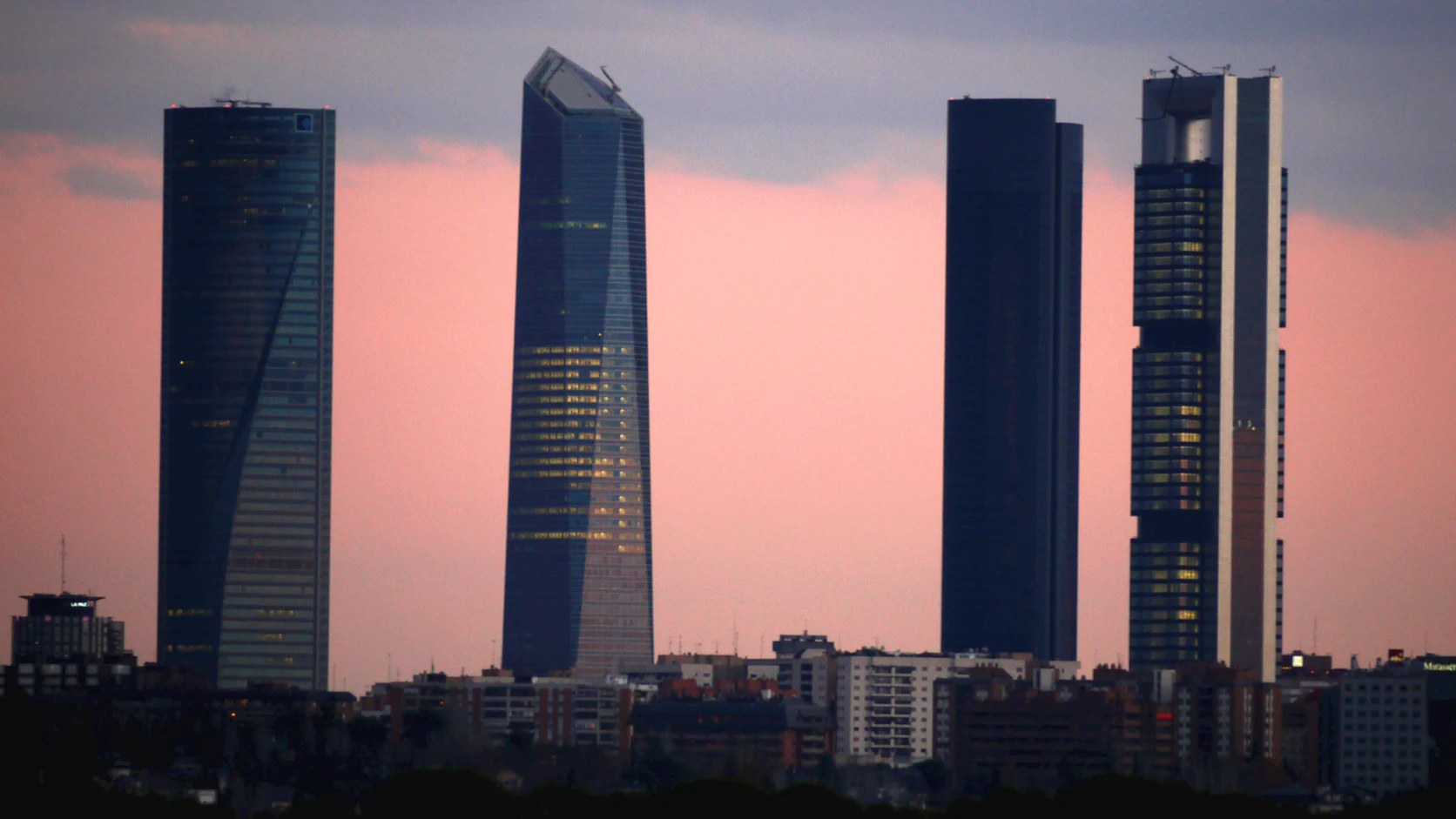 Cuatro Torres Business Area in northern Madrid, showing modern commercial corporate headquarters.