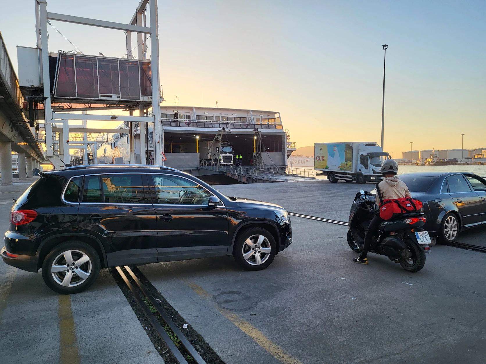 Vehicles and commercial freight trucks queueing at the Strait ferry embarkation terminal.