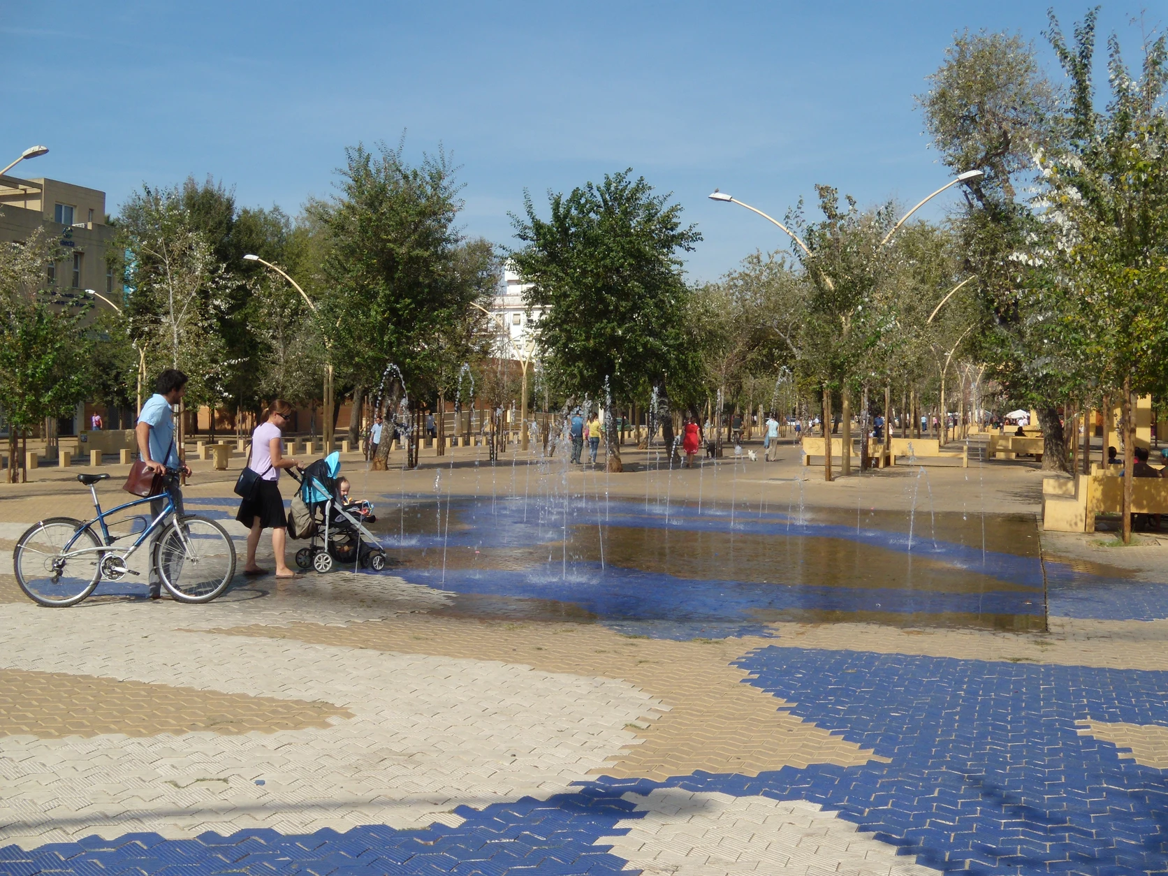 The Alameda de Hércules public promenade in Seville with mature shade trees and civic cooling space.