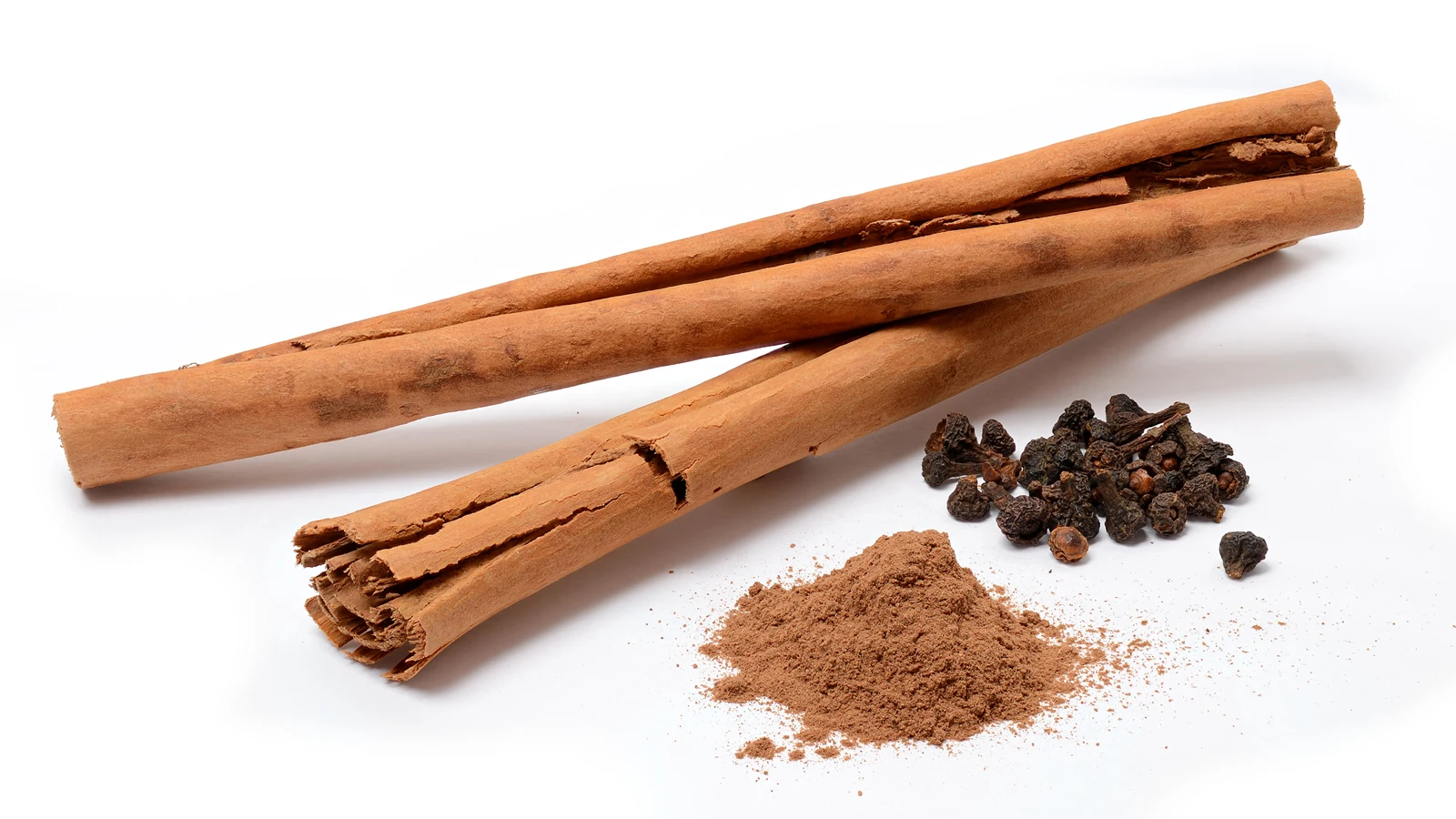 Tightly rolled Ceylon cinnamon quills and finely ground spice powder.