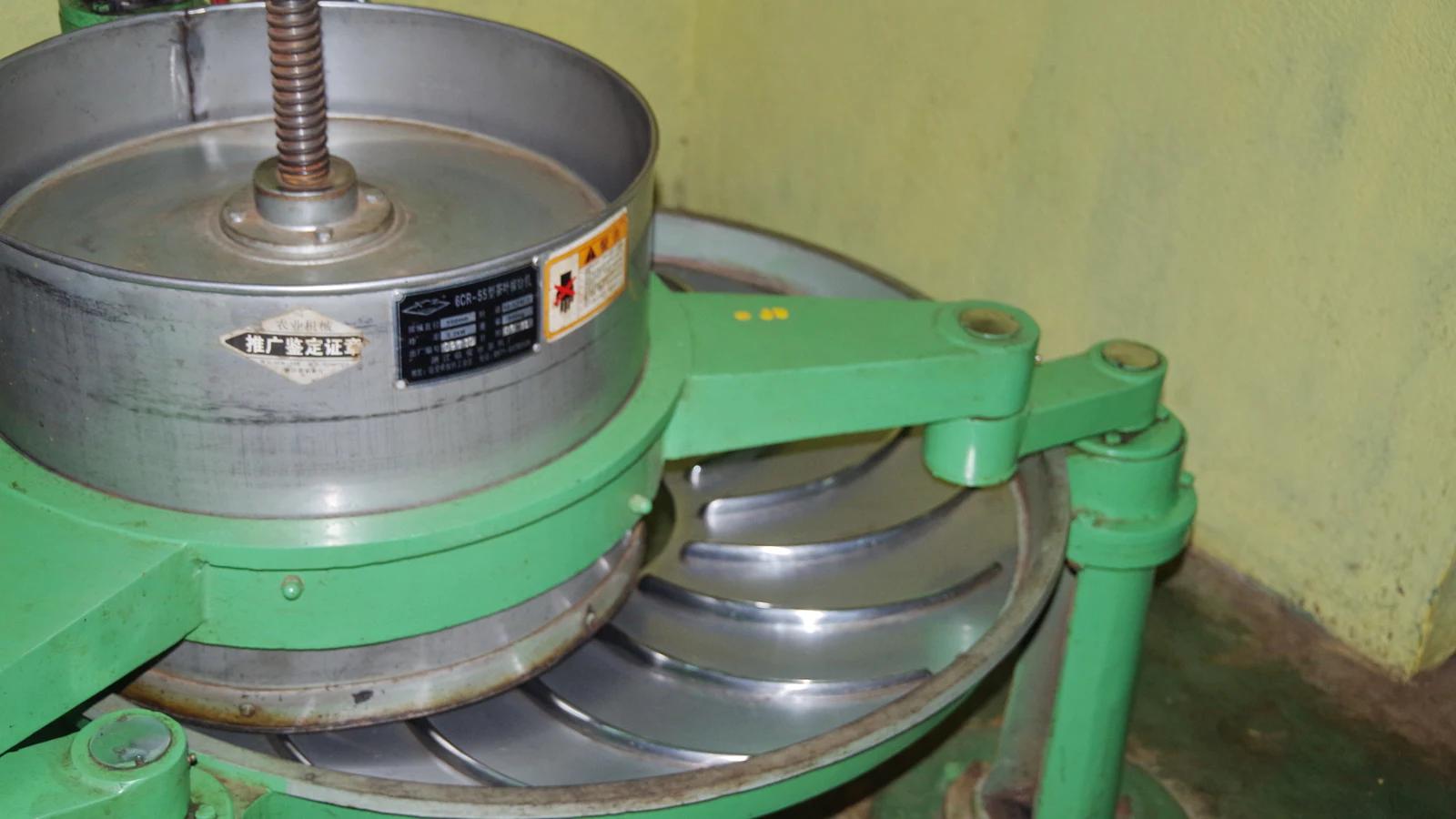 Mechanical tea leaf rolling machinery operating inside a Sri Lankan orthodox tea factory.