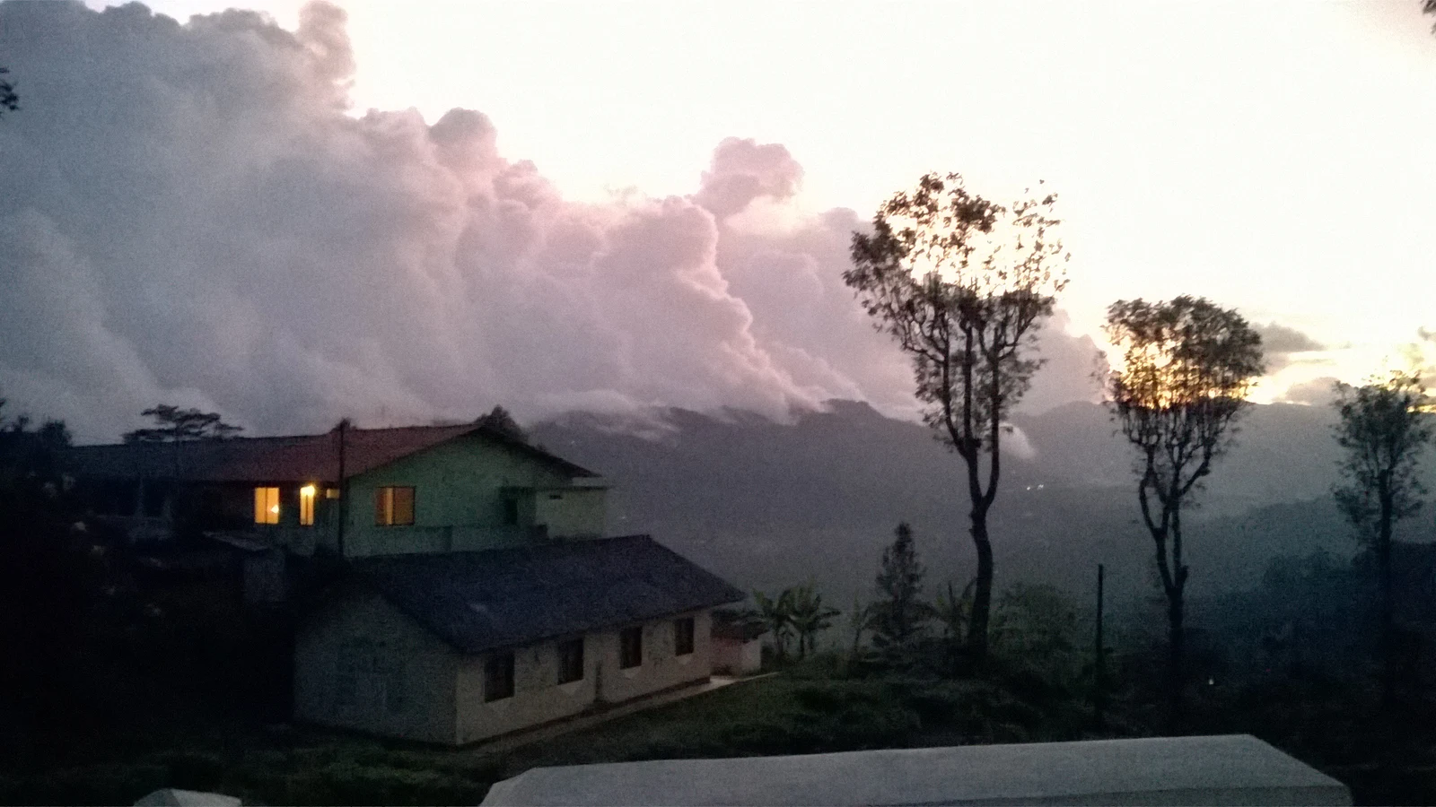 A large multi-storey tea manufacturing factory situated amidst green tea hills in Haputale.