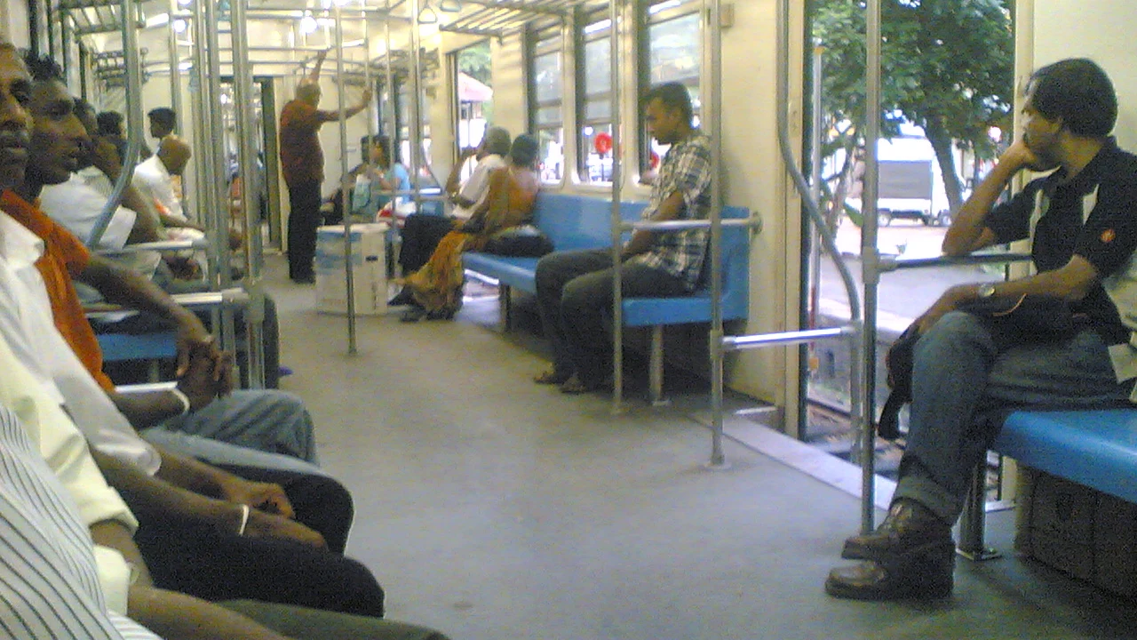 The interior of a commuter carriage on Sri Lanka Railways showing high-density seating and grab rails.