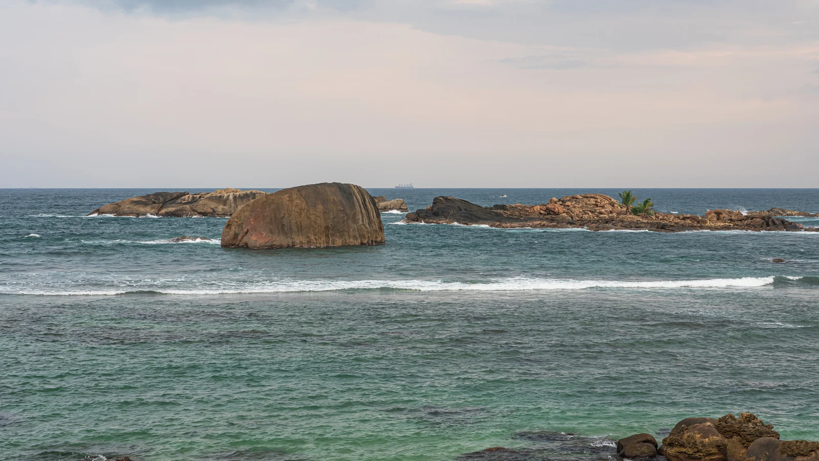 Massive stone seawall battlements and coastal promenade facing the open Indian Ocean.