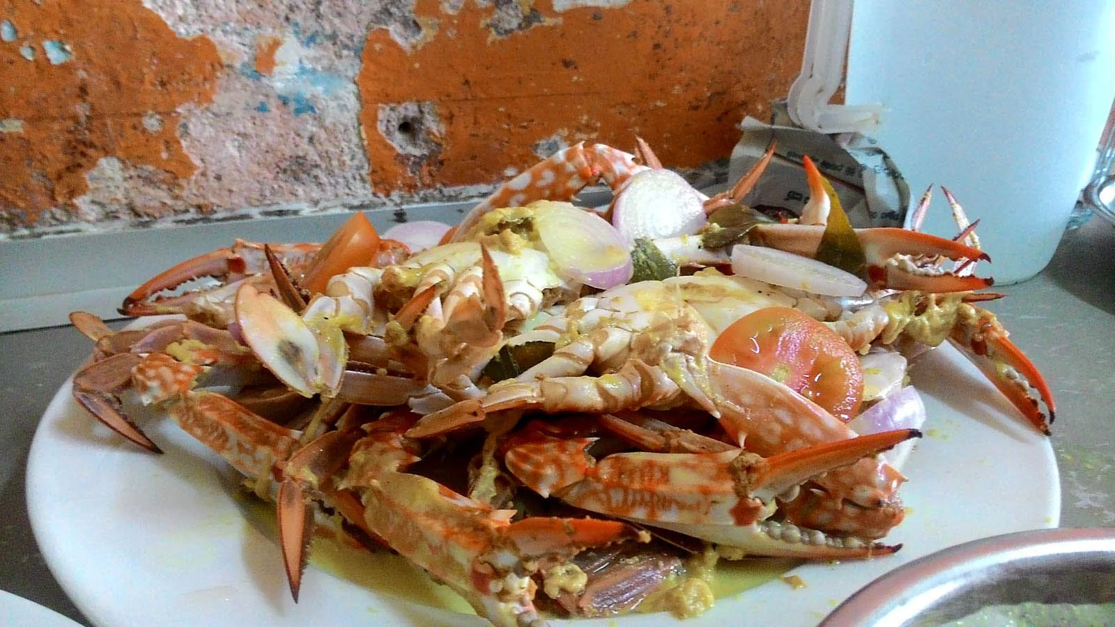 Freshly landed mangrove mud crabs displayed at coastal fish market stall.