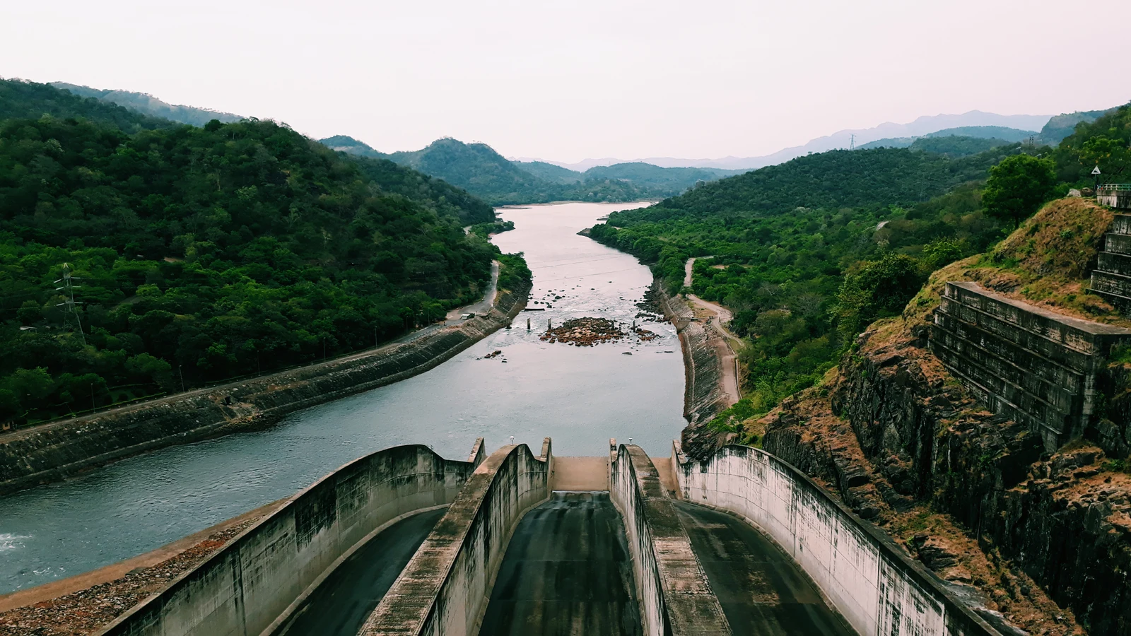 Expansive waters of Randenigala Reservoir surrounded by steep highland ridges.