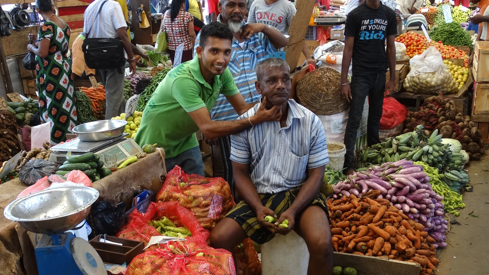 Bustling wholesale trading street with handcarts and produce merchants in Pettah, Colombo.