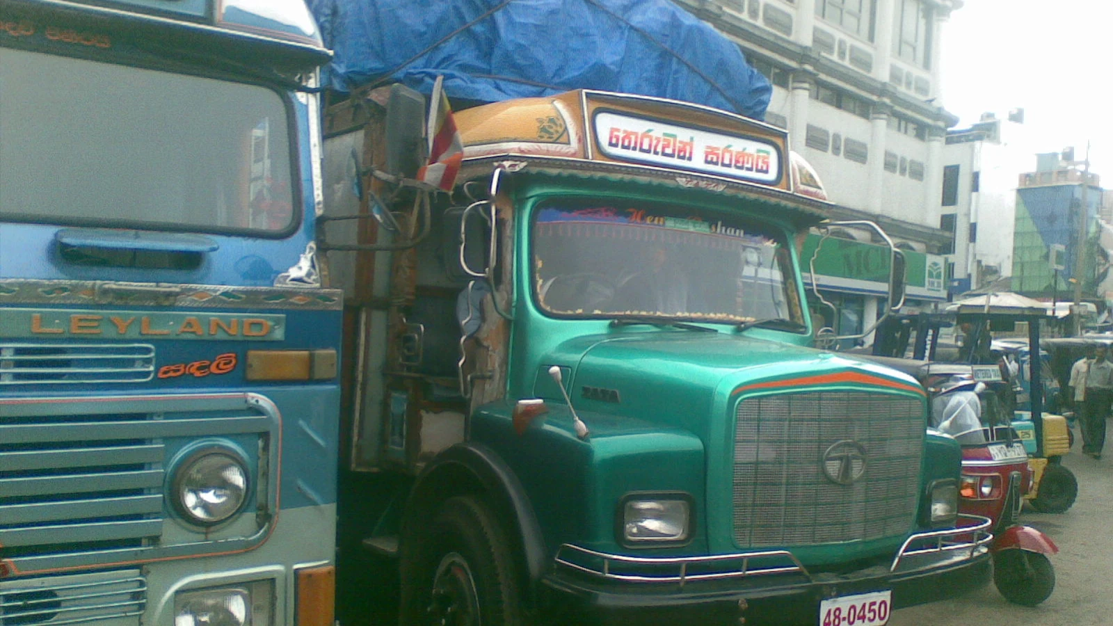 Commercial store facades and delivery vehicles along 5th Cross Street in Pettah.