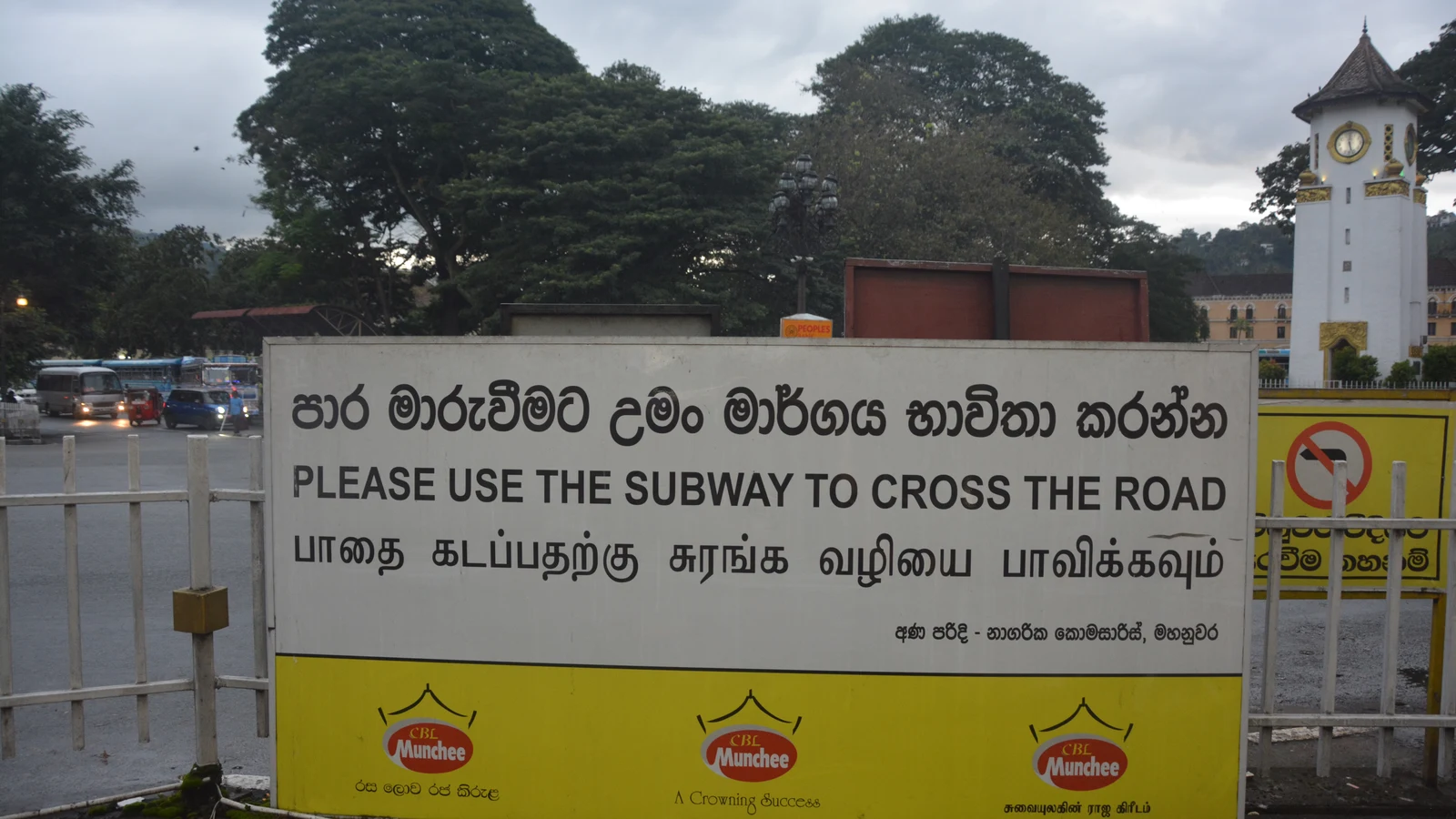 A prominent public street sign in Sri Lanka displaying instructions simultaneously in Sinhala, Tamil, and English.
