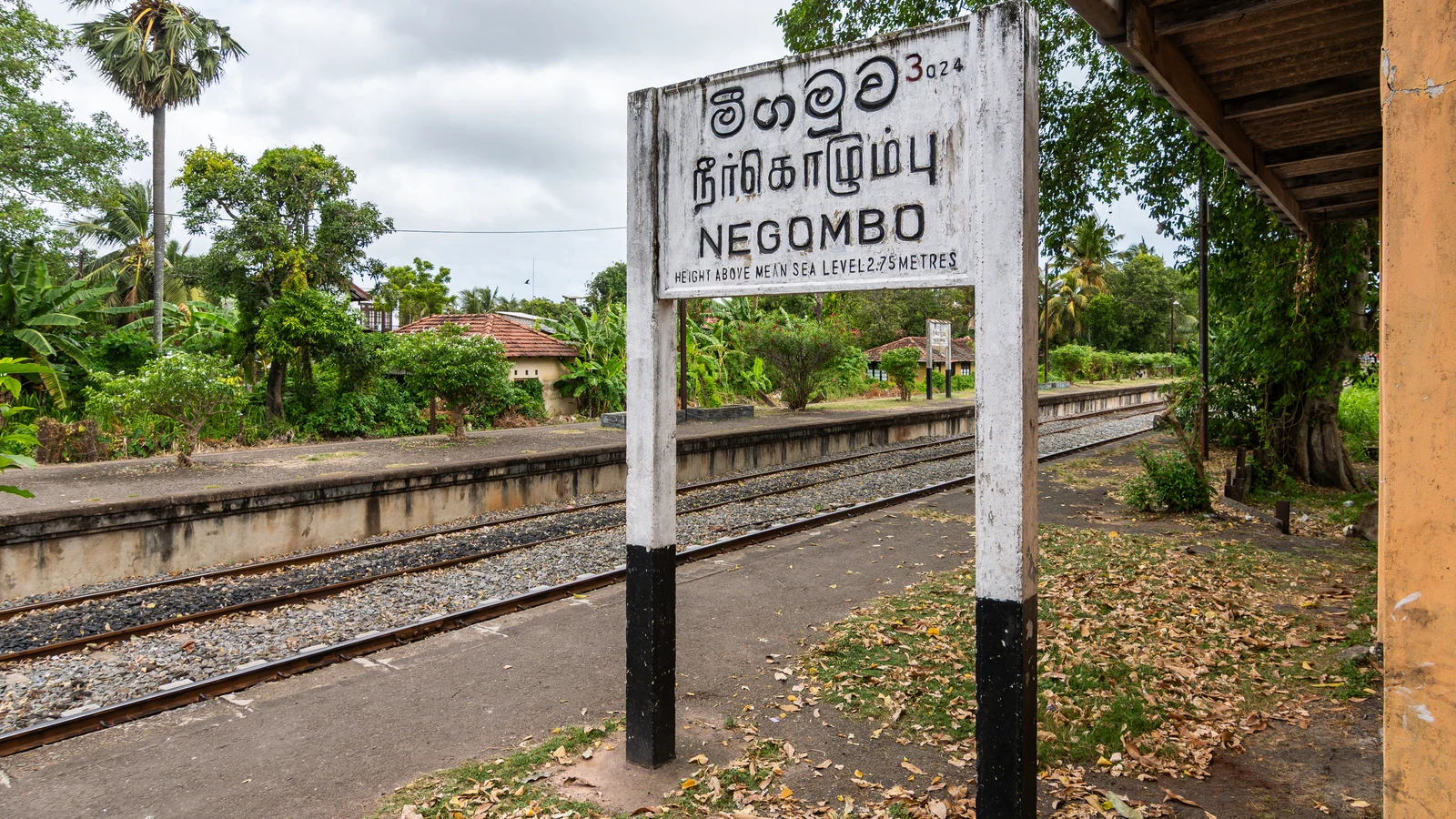 Platform signage and passenger information board at Negombo railway station.
