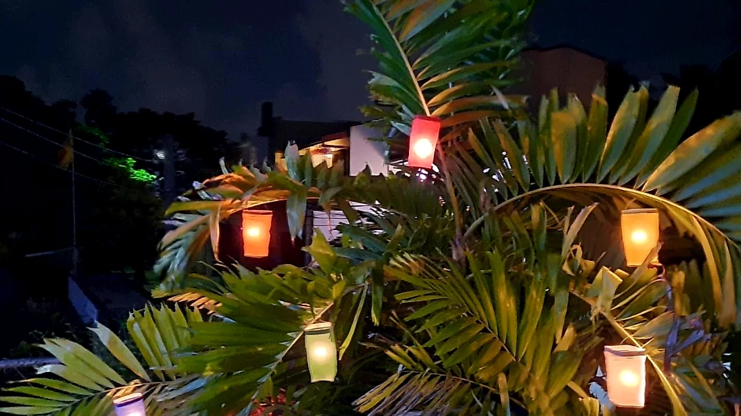 Traditional geometric paper lanterns glowing warmly at night during the Vesak festival.