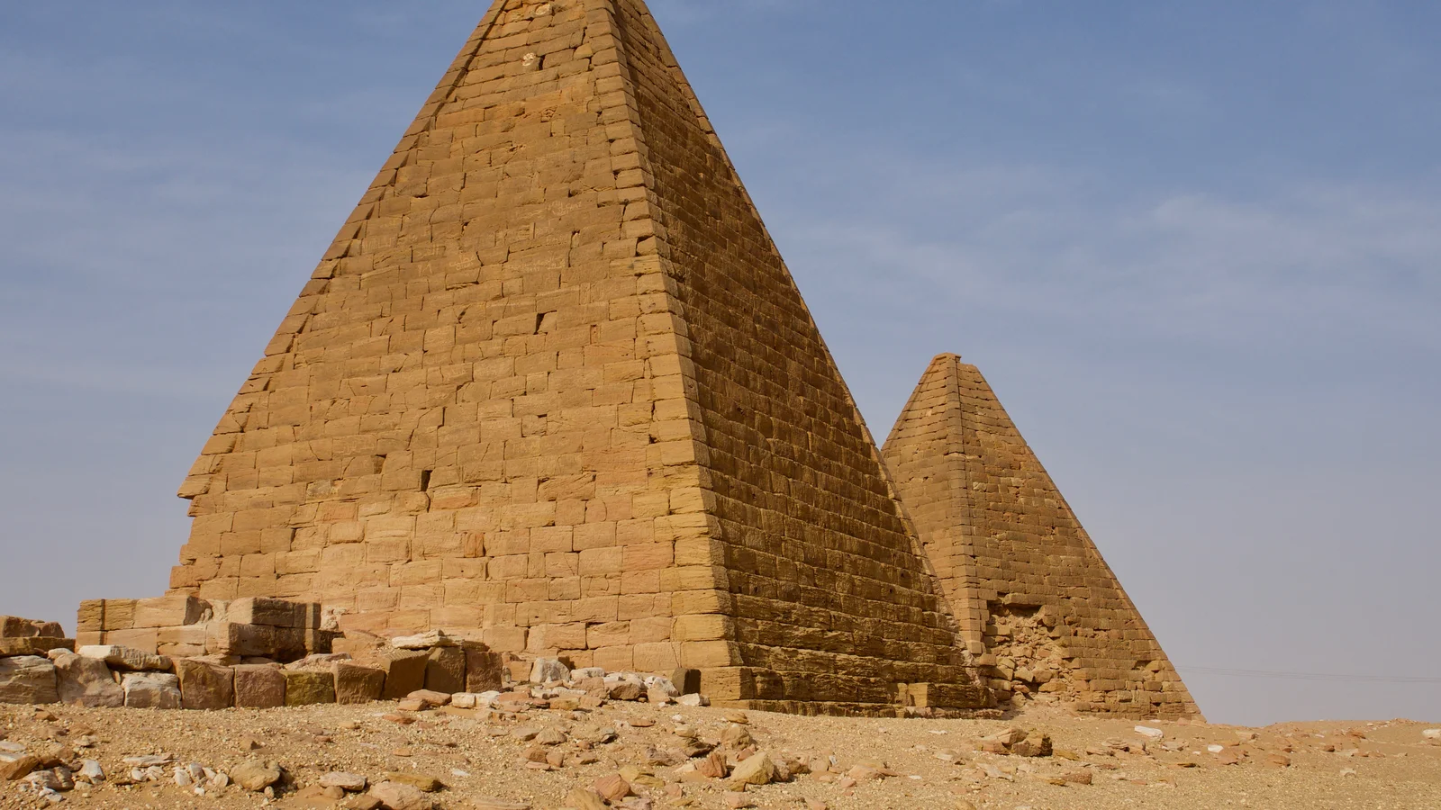 Restored sandstone burial chambers and pyramid chapels across the royal necropolis of Jebel Barkal.