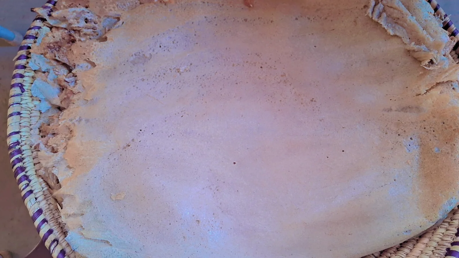 A completed platter of folded kisra bread prepared for communal serving in Sudan.