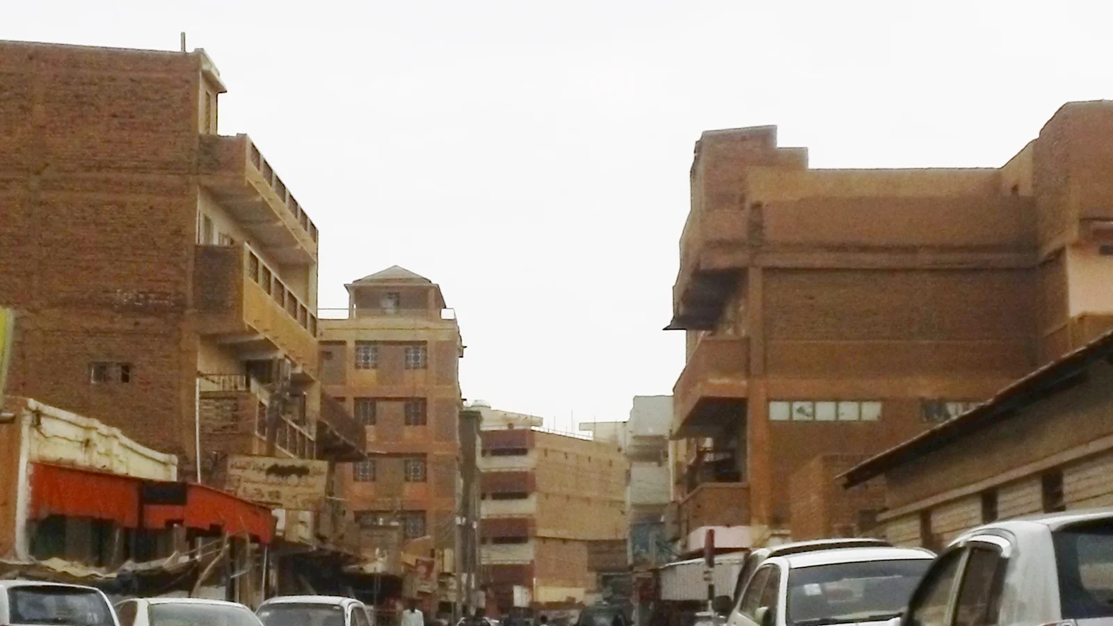 Wholesale market merchants and buyers conducting business inside the alleys of Souq Omdurman.