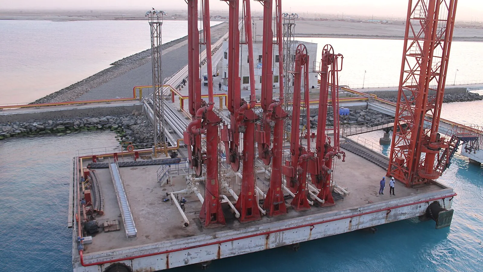Quayside ship-to-shore gantry cranes and stacked shipping containers at the southern terminal.