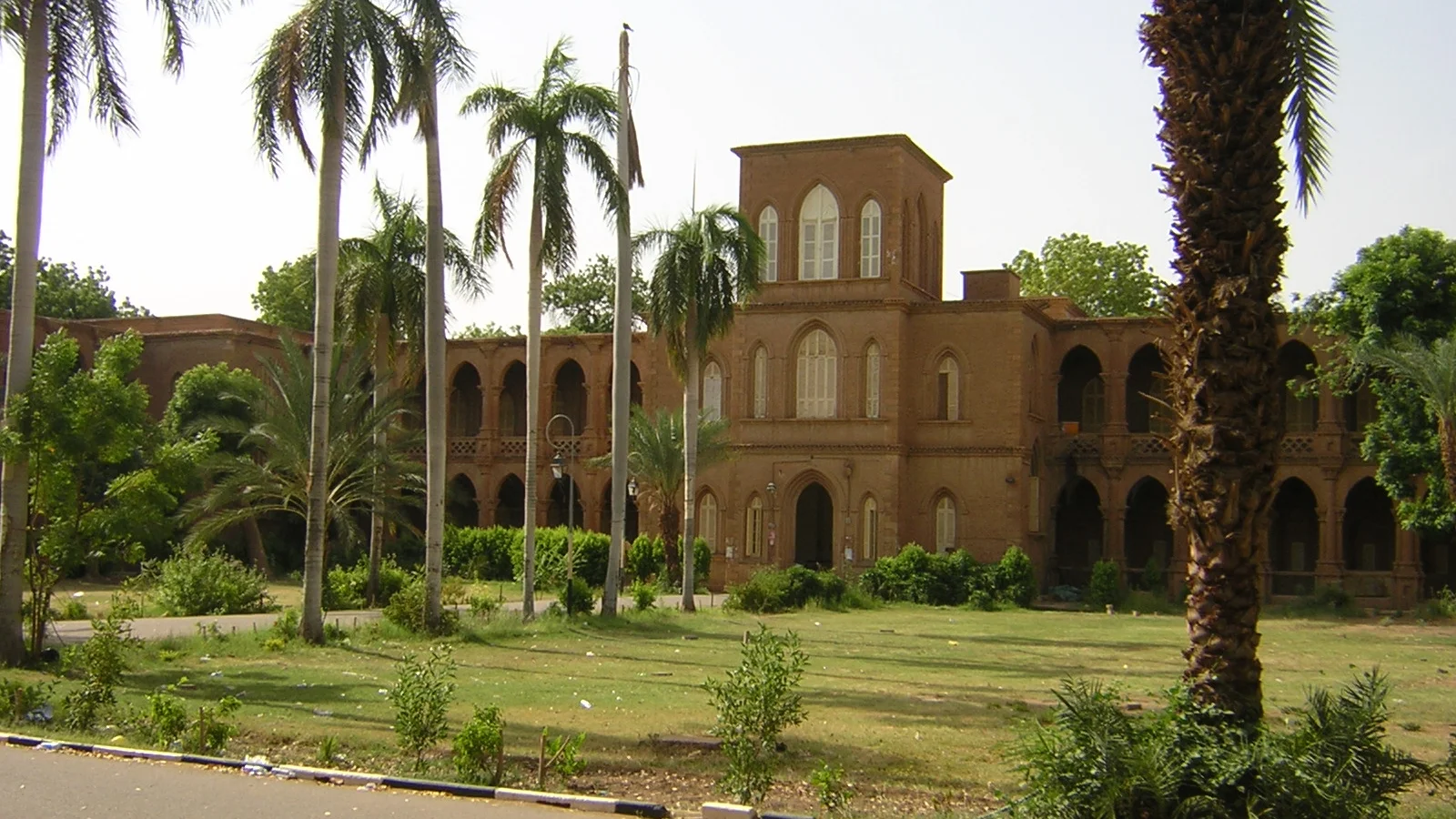 Colonnaded academic building with administrative department signage in Khartoum.