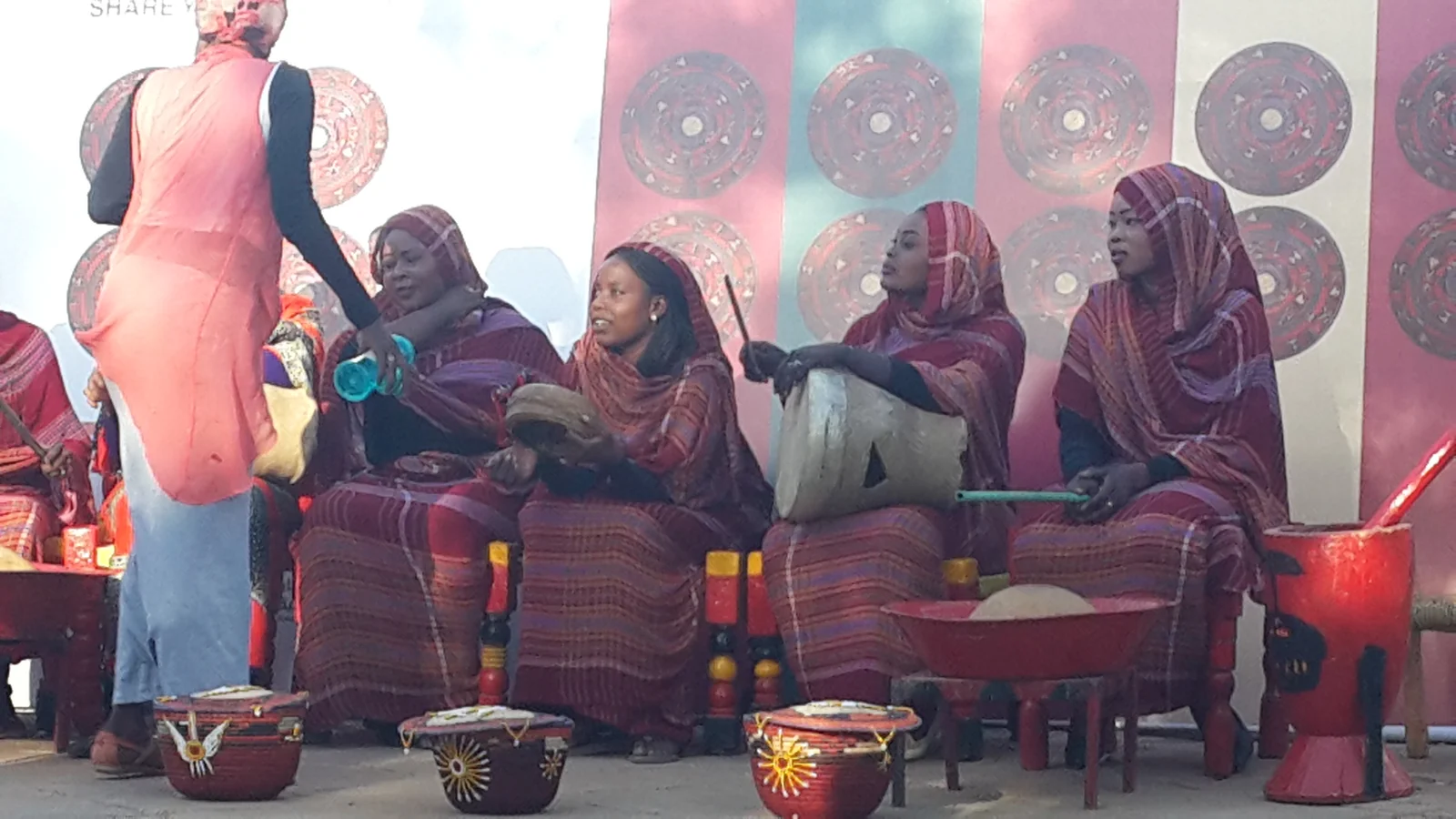 Sudanese women singing traditional folk songs accompanied by a traditional frame drum.