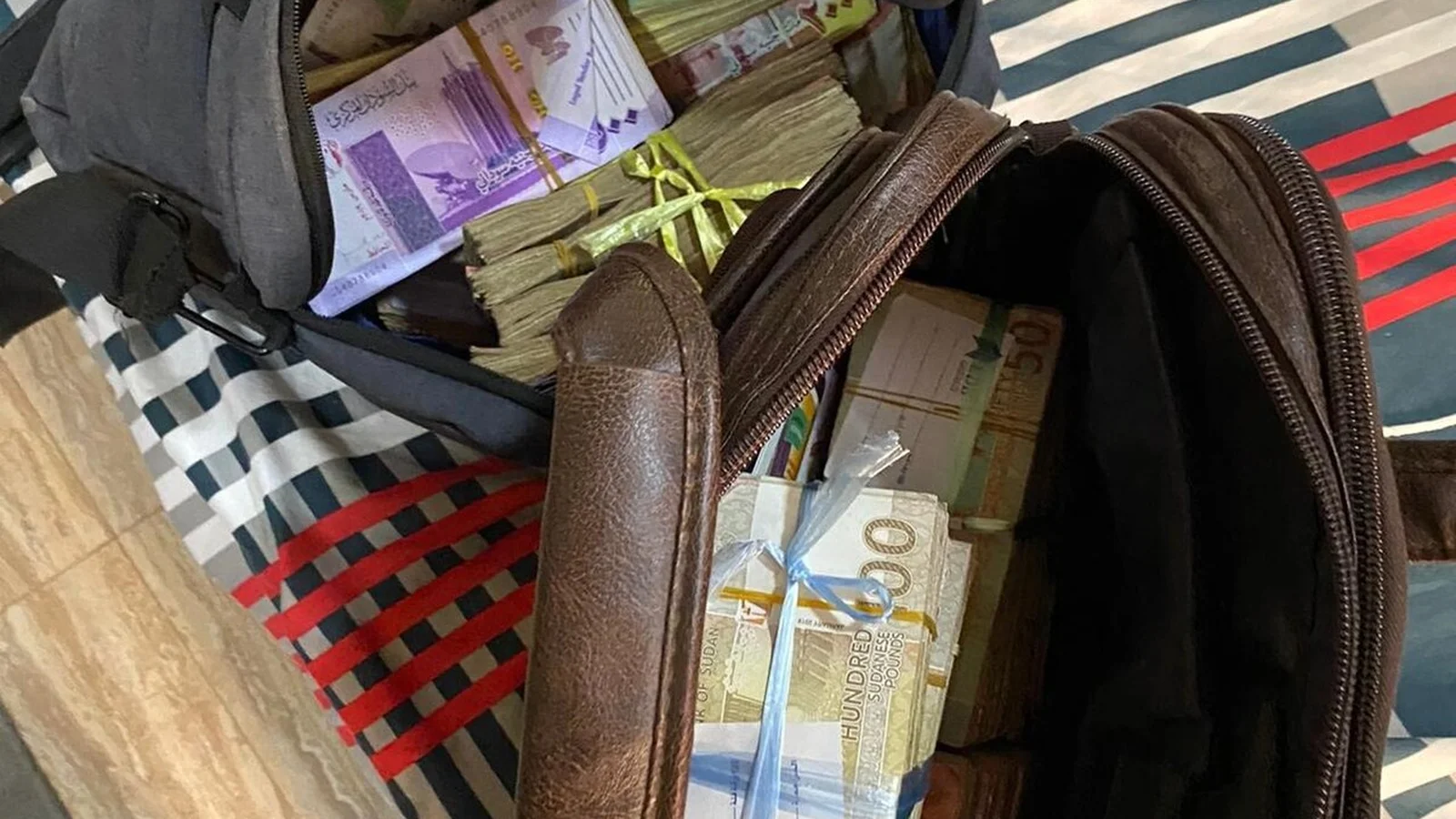 Thick stacked bundles of Sudanese pound banknotes illustrating consumer price inflation and cash circulation.