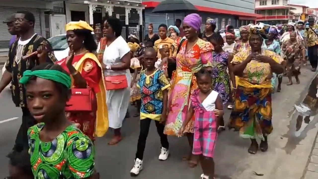 Citizens and community groups processing down the streets of Paramaribo during the Keti Koti national holiday.