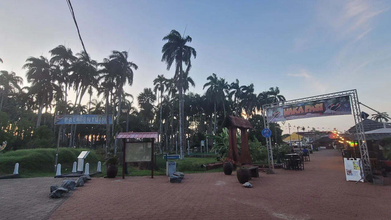 Illuminated public grounds of Palmentuin at night as post-festival municipal crews begin logistical teardown.