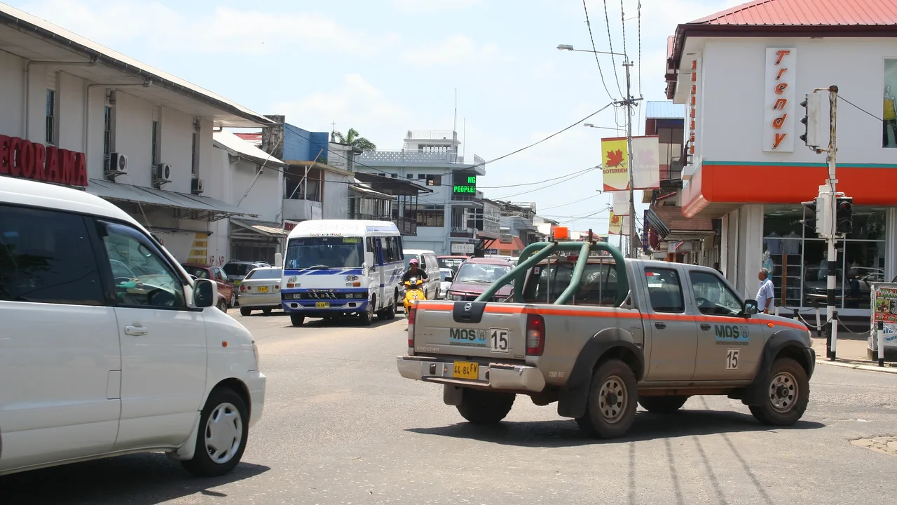 Cleaned, quiet colonial timber street in central Paramaribo ready for morning traffic.