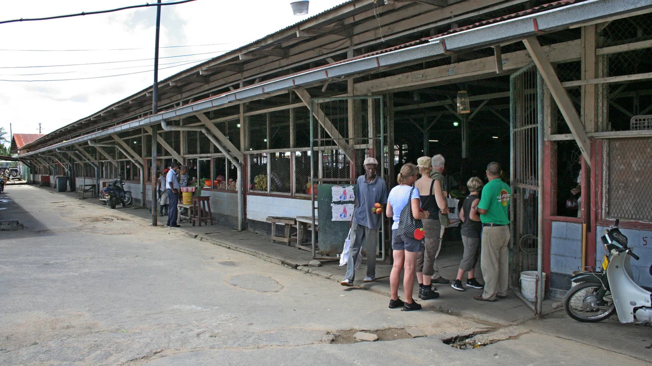 Open-air market vendors and commercial trading booths at the Dassasingh retail market complex in southern Paramaribo.