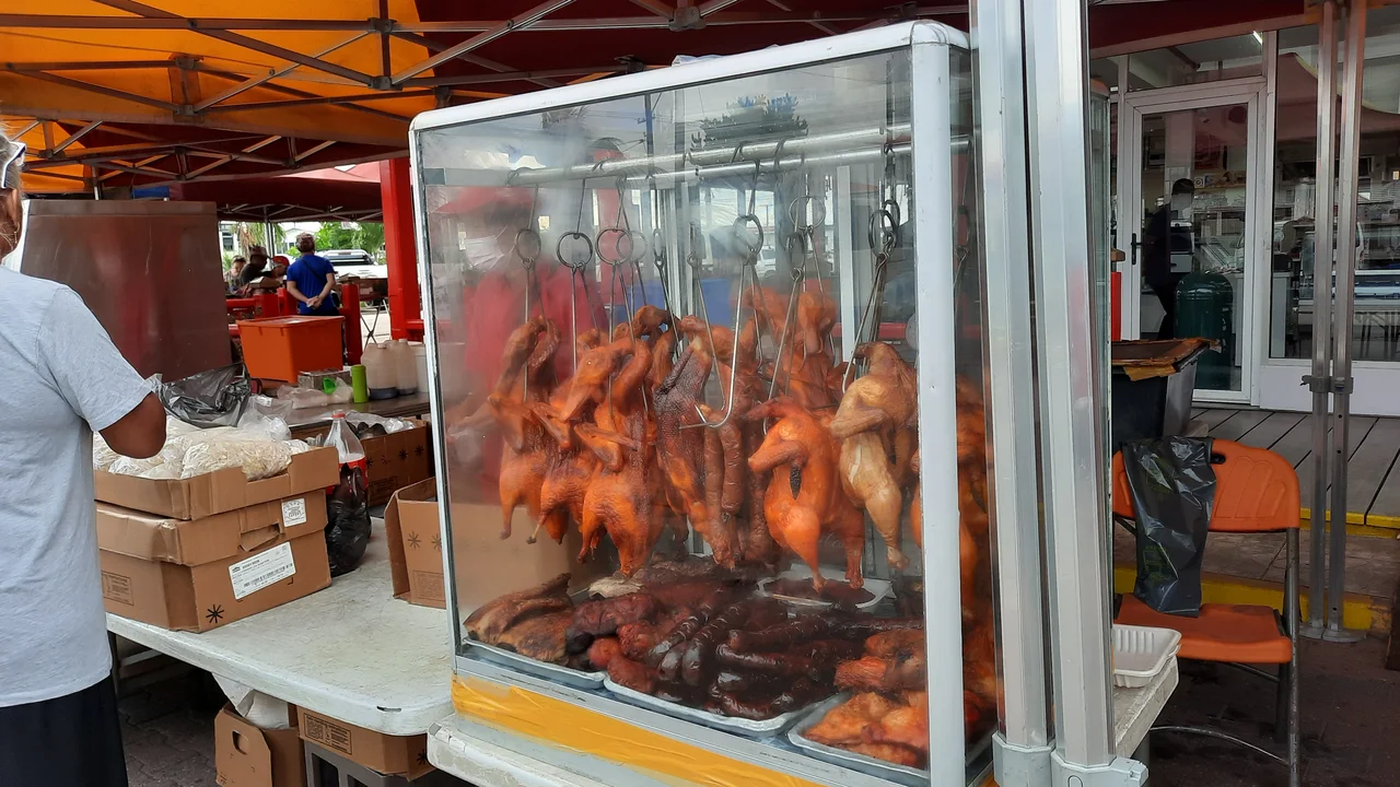 Vibrant Sunday morning retail market stalls and food commerce along Wilhelminastraat in Paramaribo.