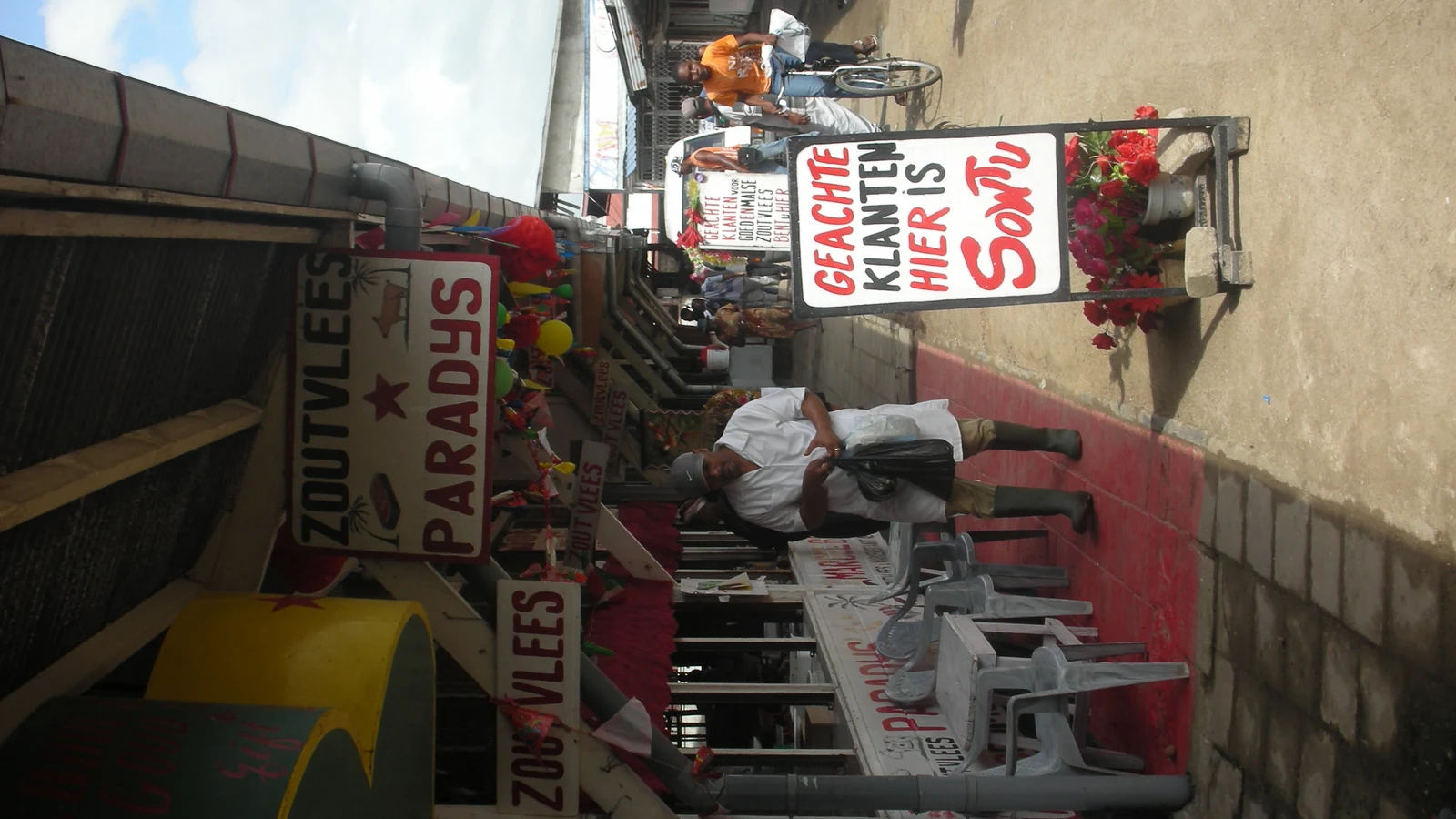 Butcher and seafood counter inside the municipal market with displayed fresh meats.