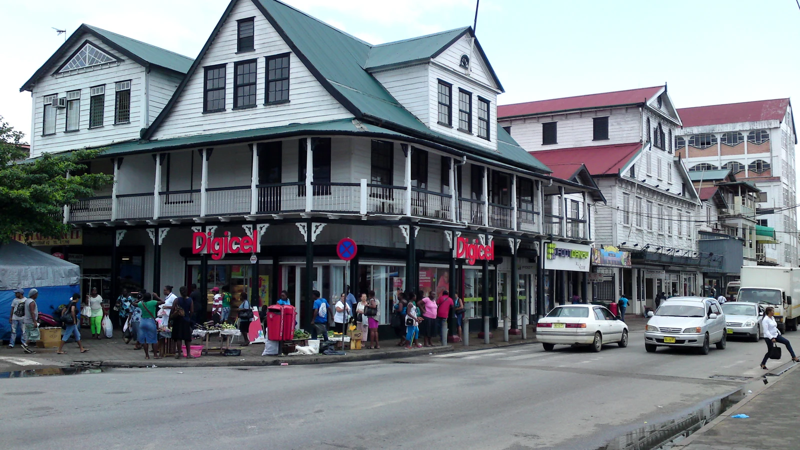 Row of historic white wooden colonial merchant residences along the Waterkant in Paramaribo.